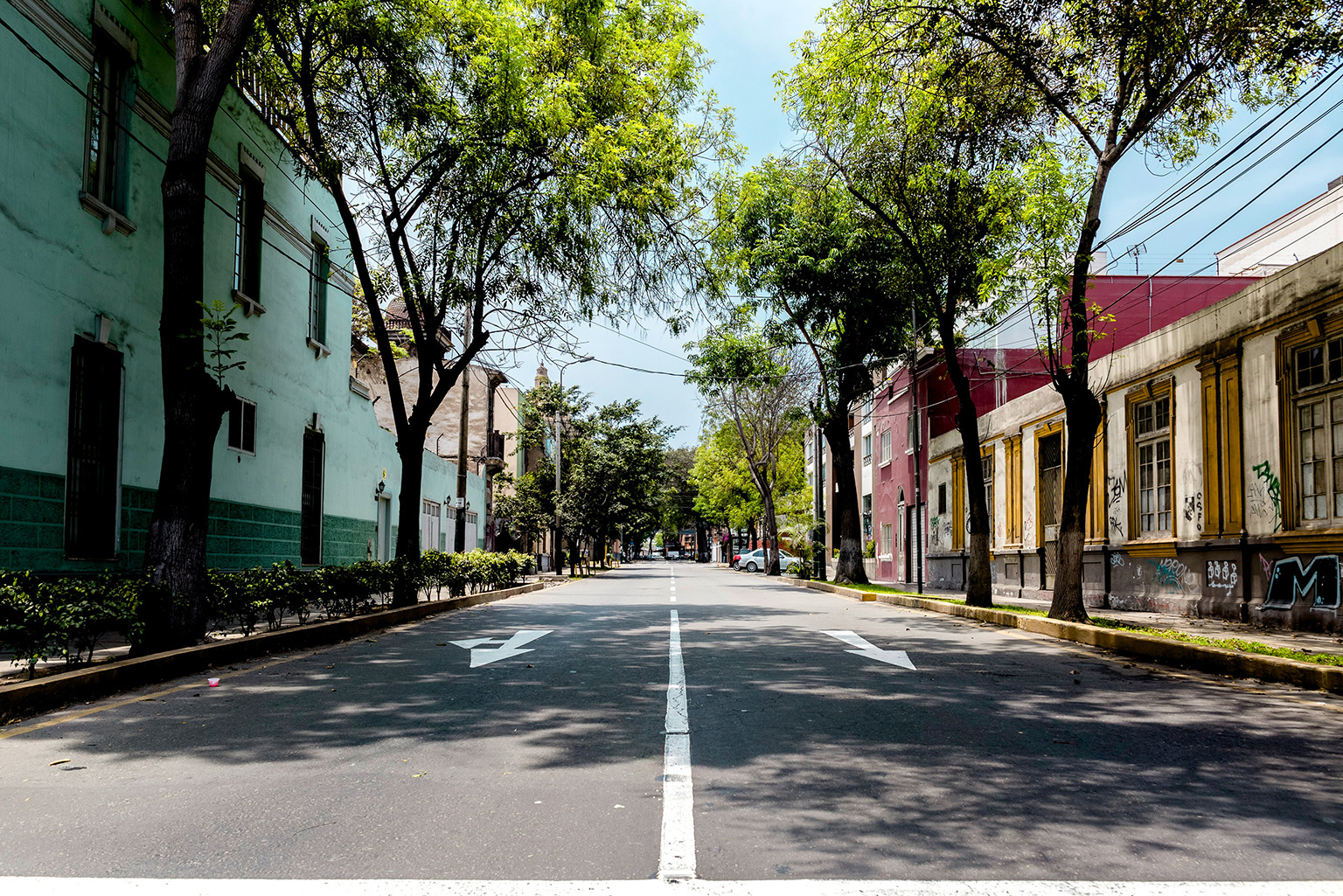 A deserted upscale street in a town in Peru, featuring elegant buildings, cobblestone streets, and a peaceful, serene atmosphere.