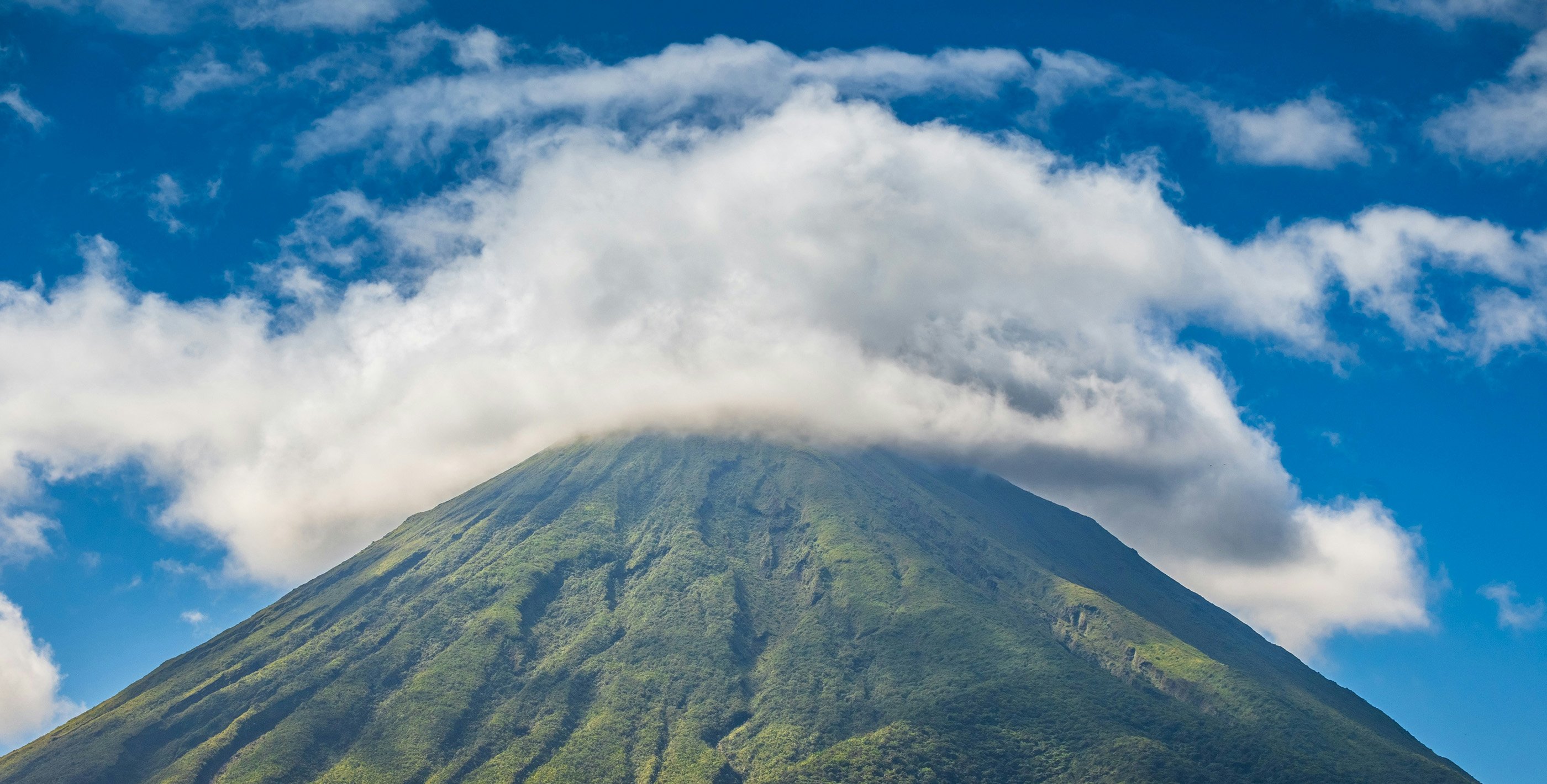 Living in Latin America this volcano with the top covered in clouds is a common sight