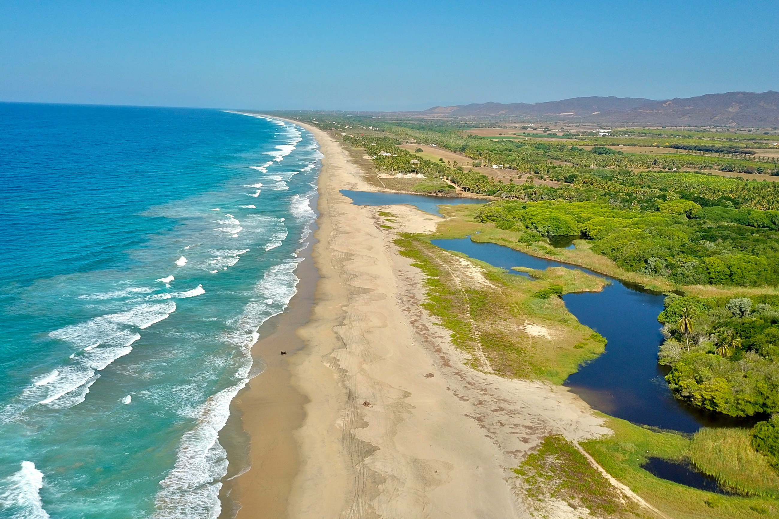 Secluded beach with turquoise waters in one of the most popular places in Mexico to live, Puerto Escondido.