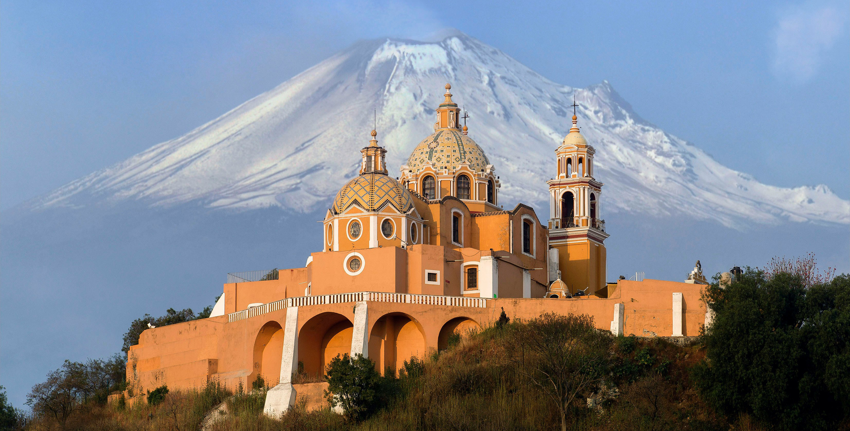 Church of Nuestra Señora de los Remedios with Popocatépetl volcano in the background, capturing one of the best places in Mexico to live.