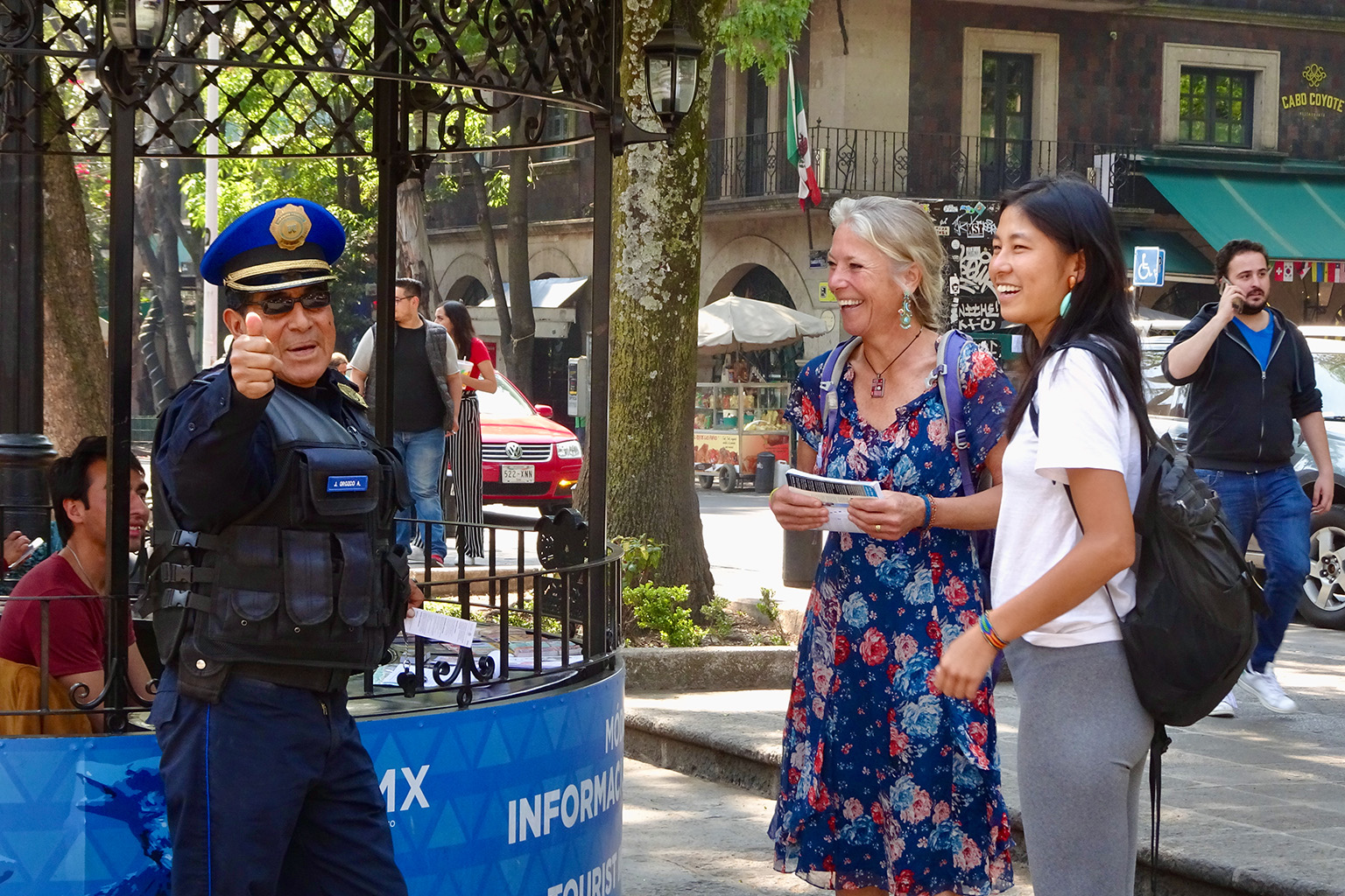Colombian police talking to a man in the street.
