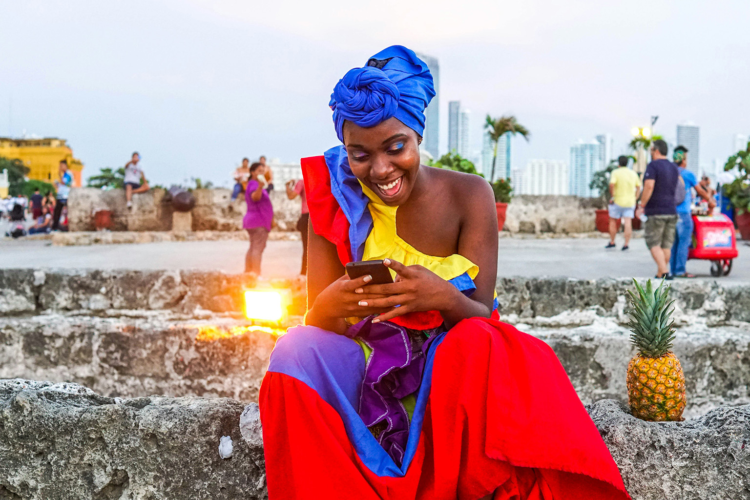 Colombian woman in traditional dress using her cell phone.