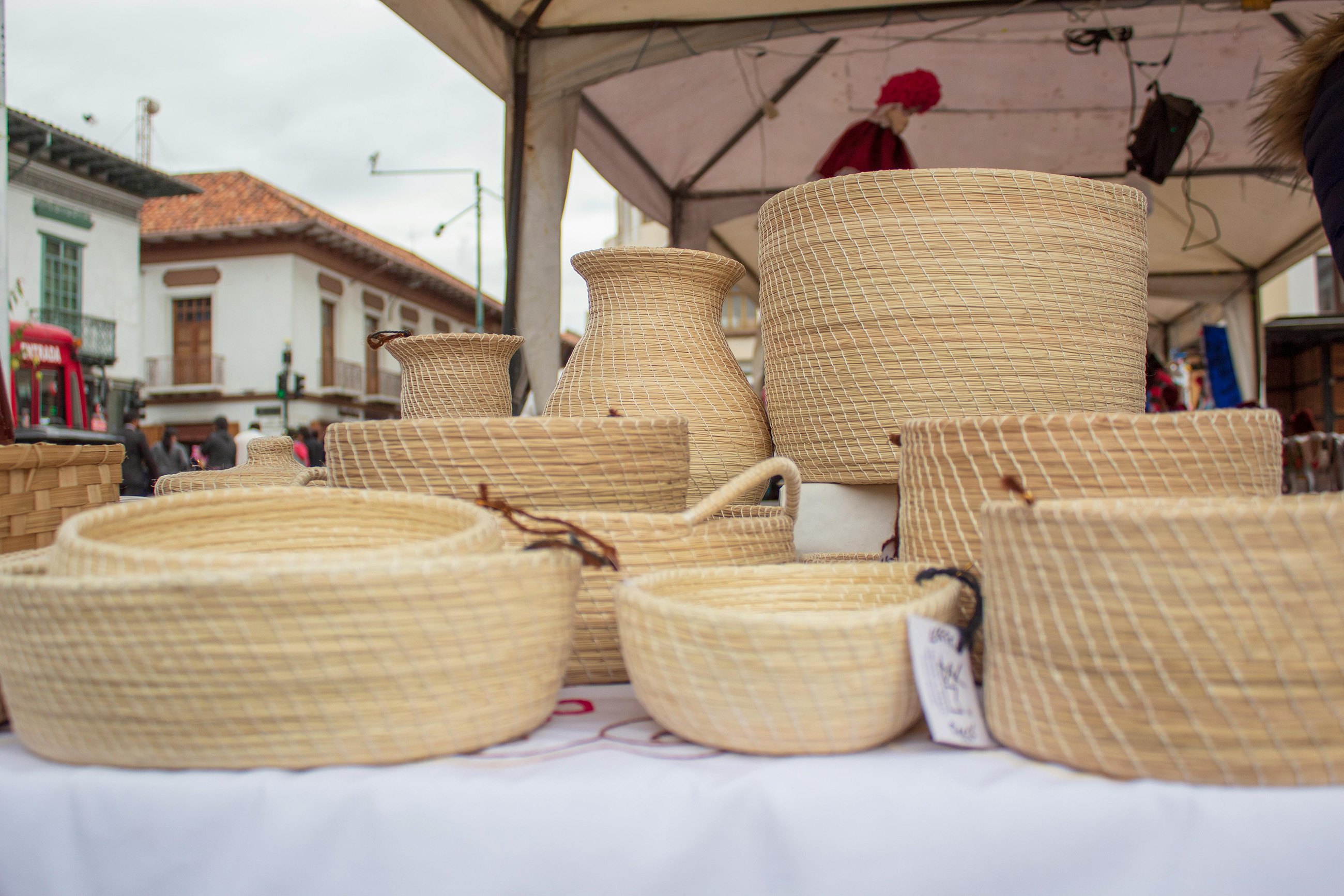 A display of handcrafted bamboo boxes at a market in Ecuador, highlighting traditional craftsmanship and local artistry.
