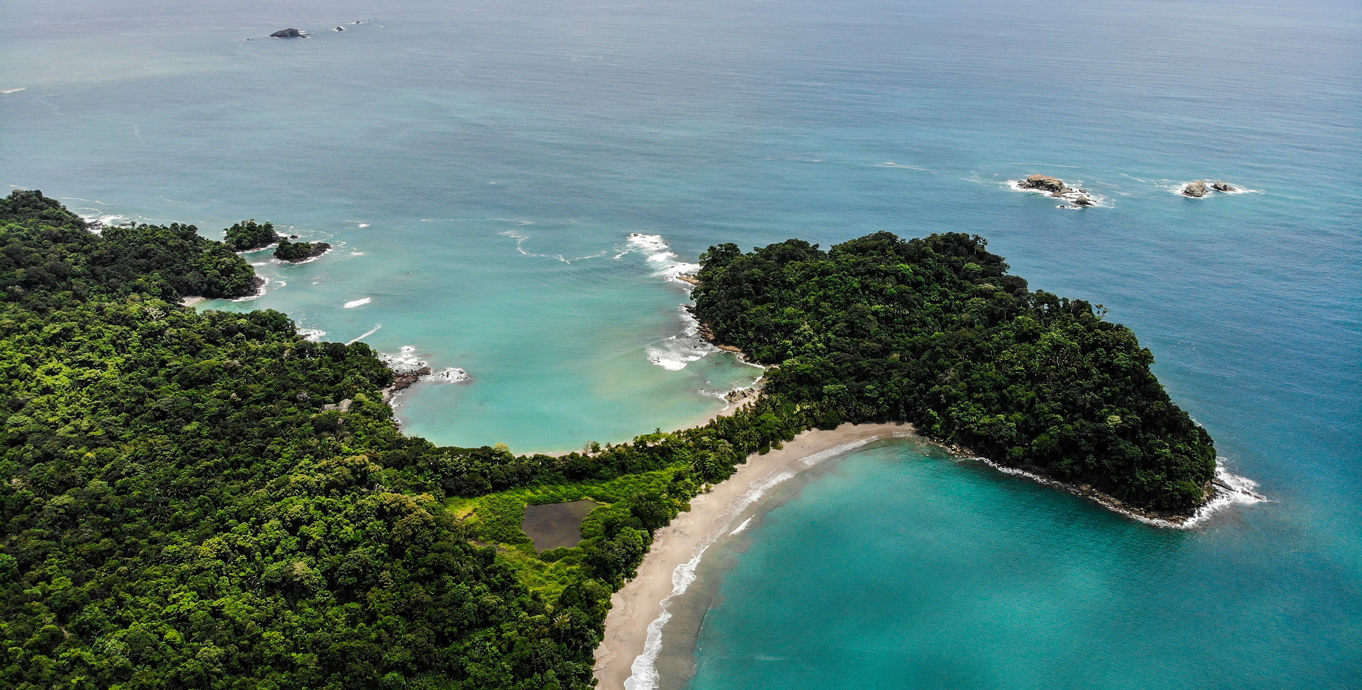 Aerial view of twin tropical beaches separated by a narrow strip of land in Costa Rica