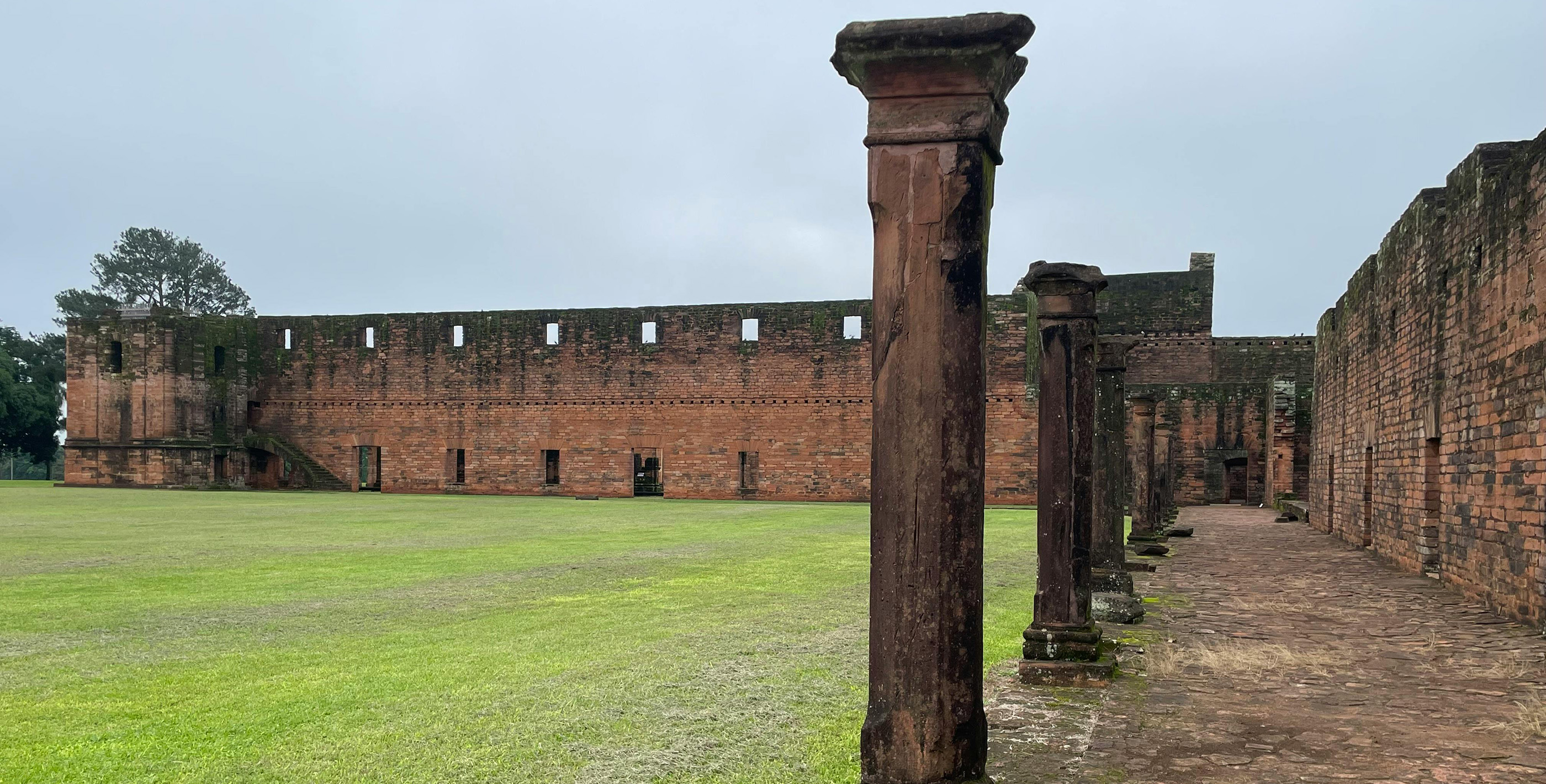 Historic ruins of a Jesuit mission surrounded by greenery in Paraguay