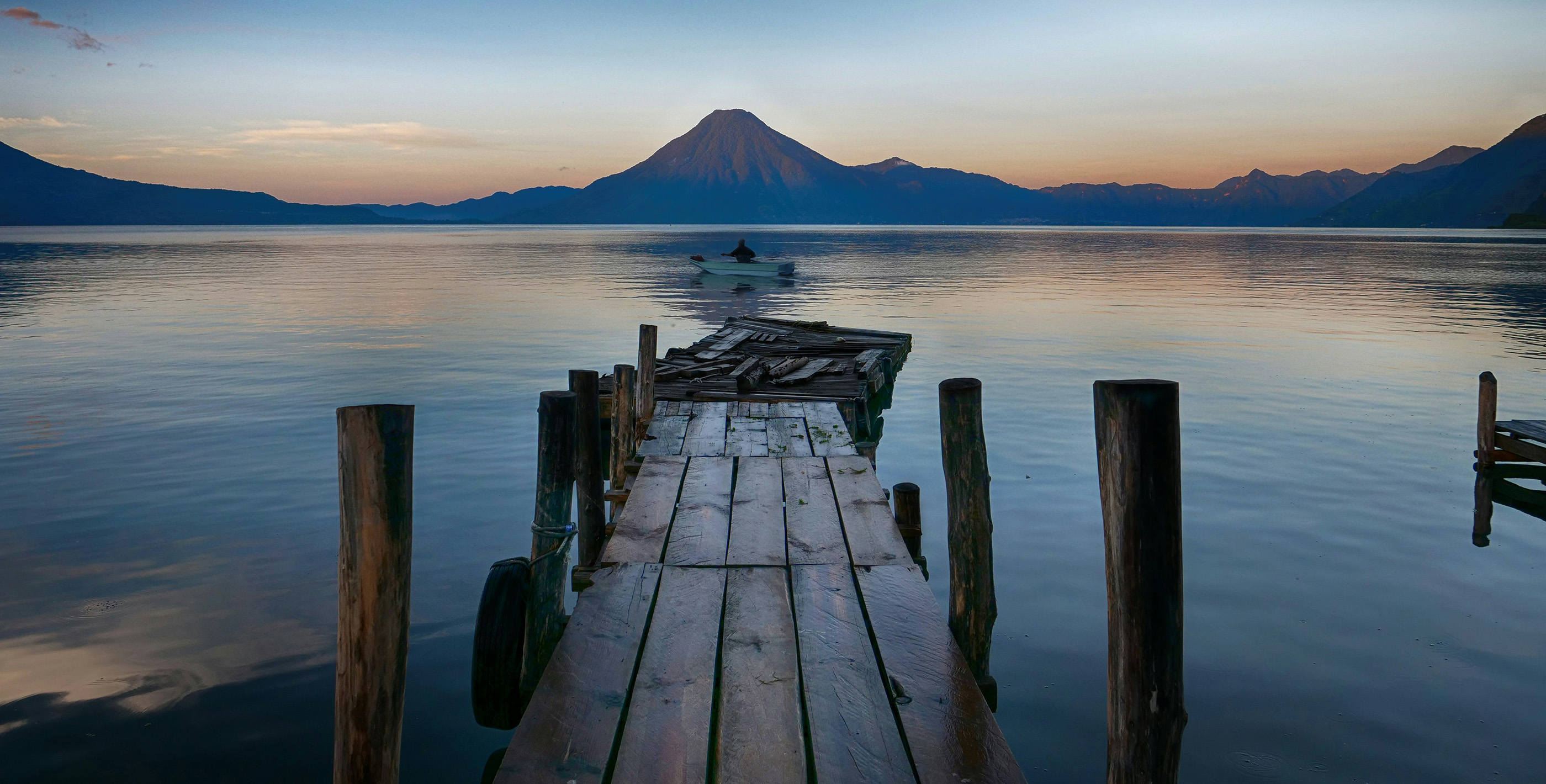 Wooden dock over Lake Atitlán with volcano in the background, Panajachel