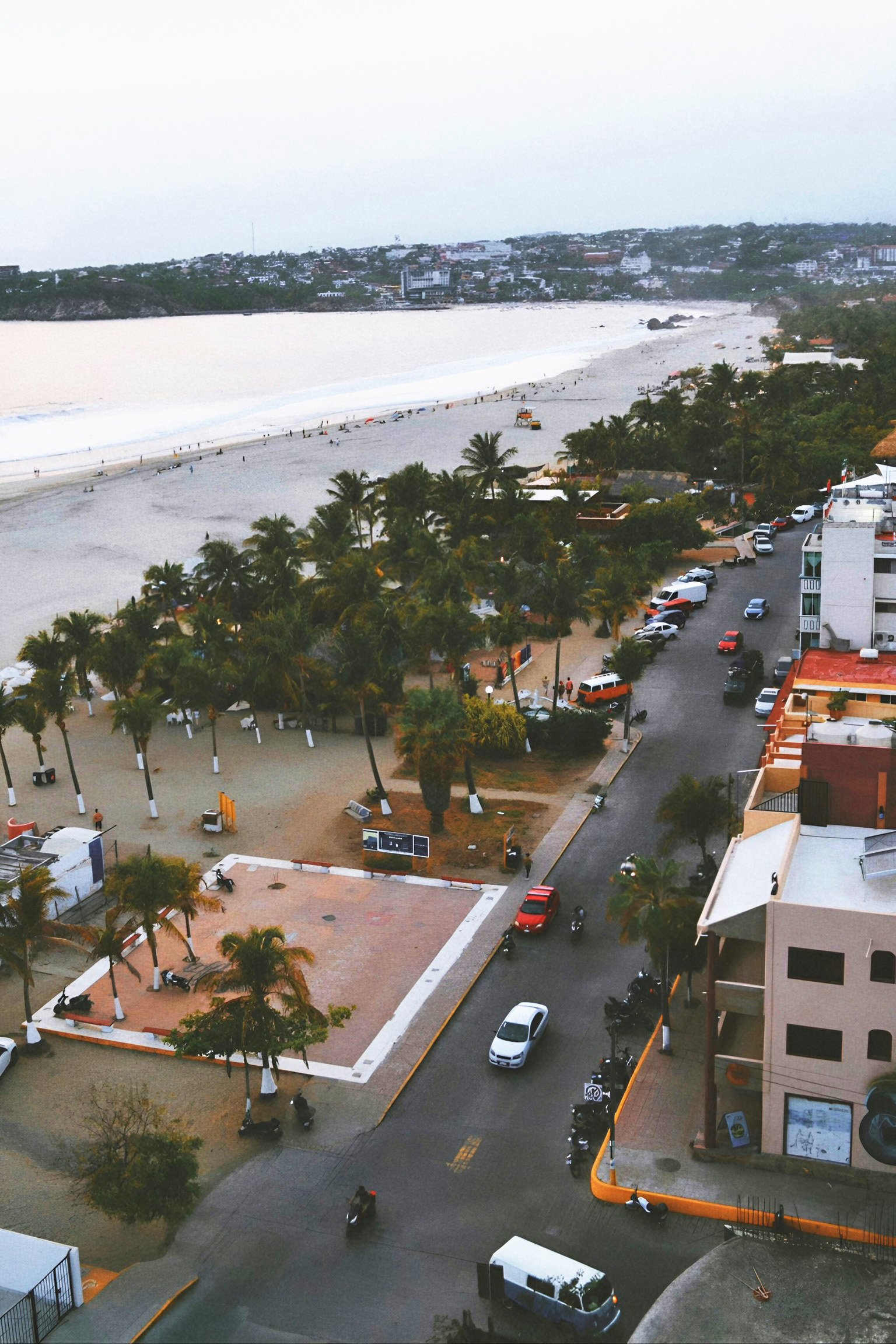 View from a window overlooking a street and the main beach when living in Puerto Escondido, Mexico