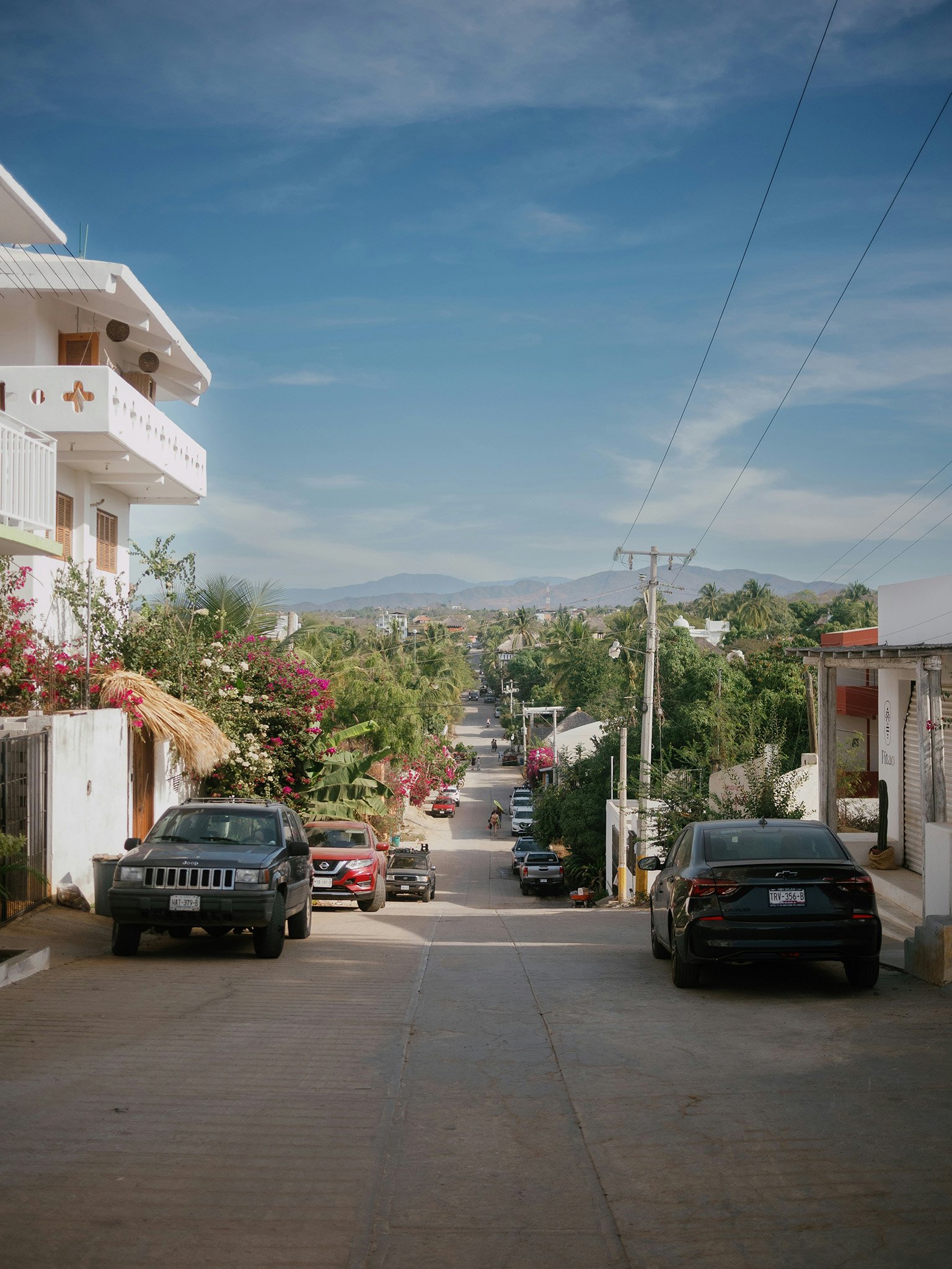 A quiet tropical street in a residential neighborhood of Puerto Escondido, Mexico.