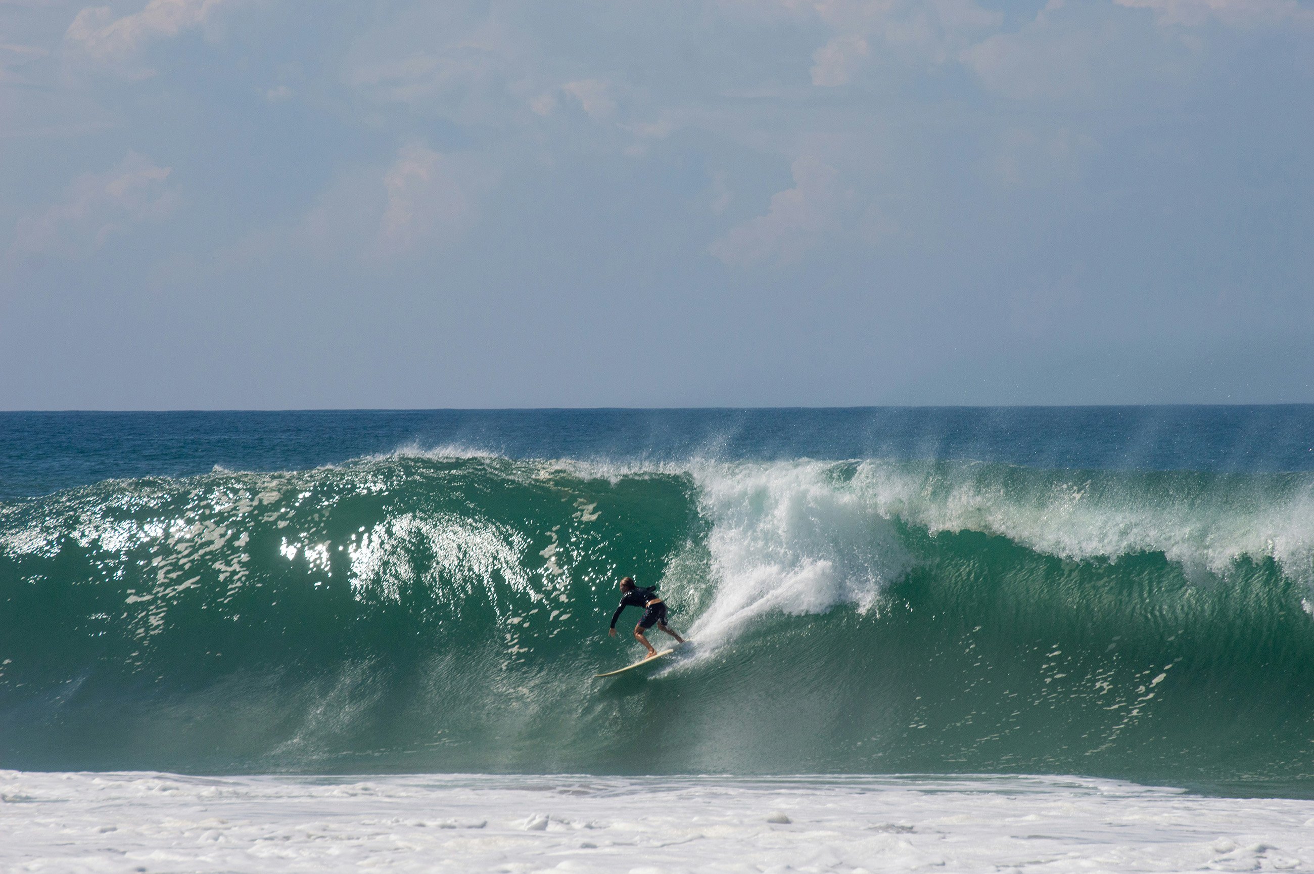 A surfer riding a massive wave at Zicatela Beach, Puerto Escondido