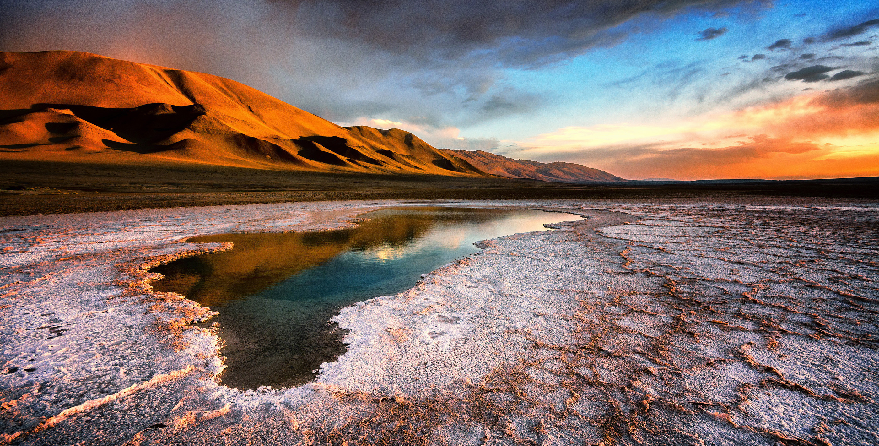 Colorful sunset over mountains, showcasing the natural beauty you can enjoy when you live in Argentina