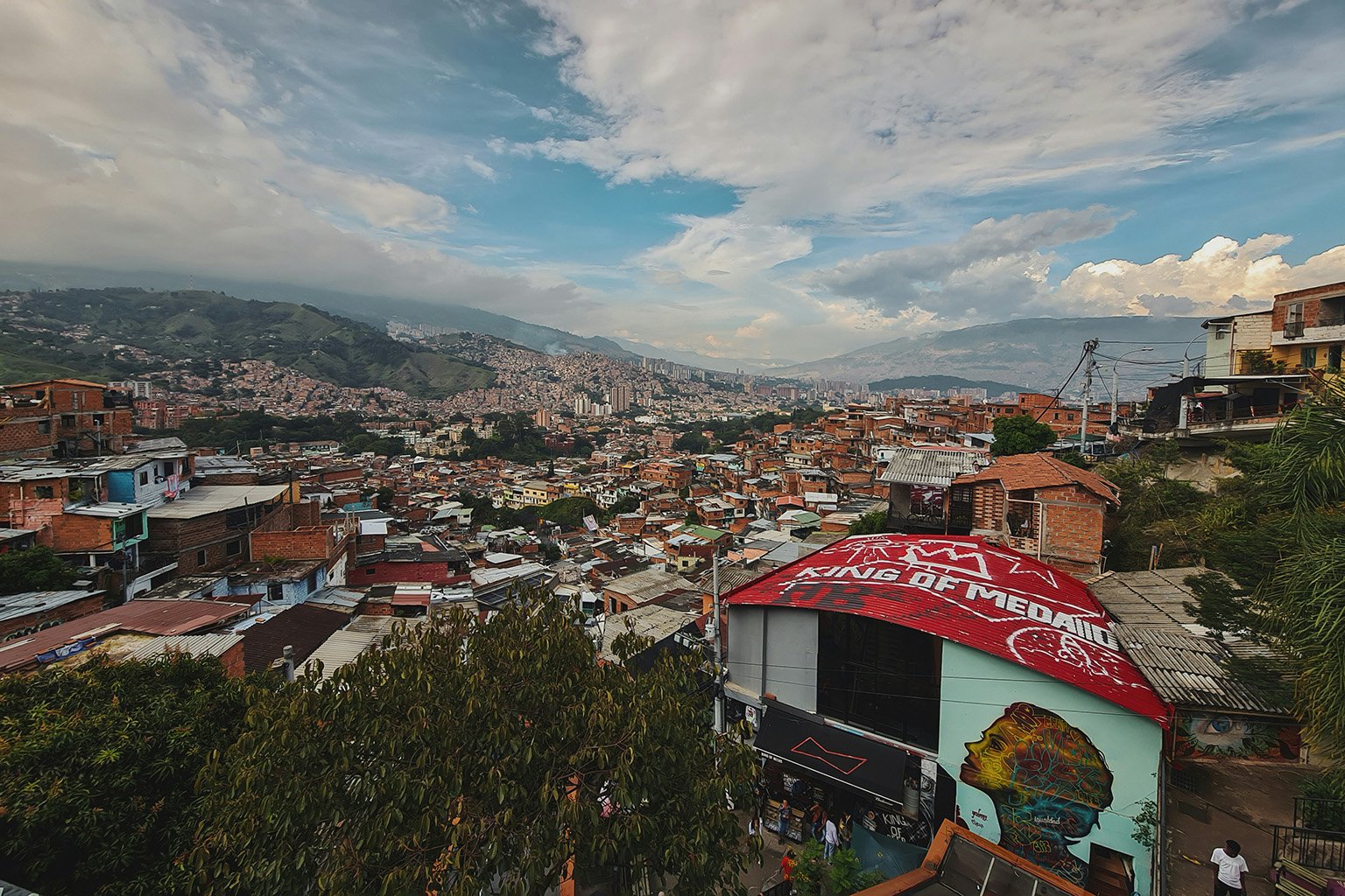 A sprawling view of Medellín, Colombia, highlighting its location in a lush valley surrounded by mountains.