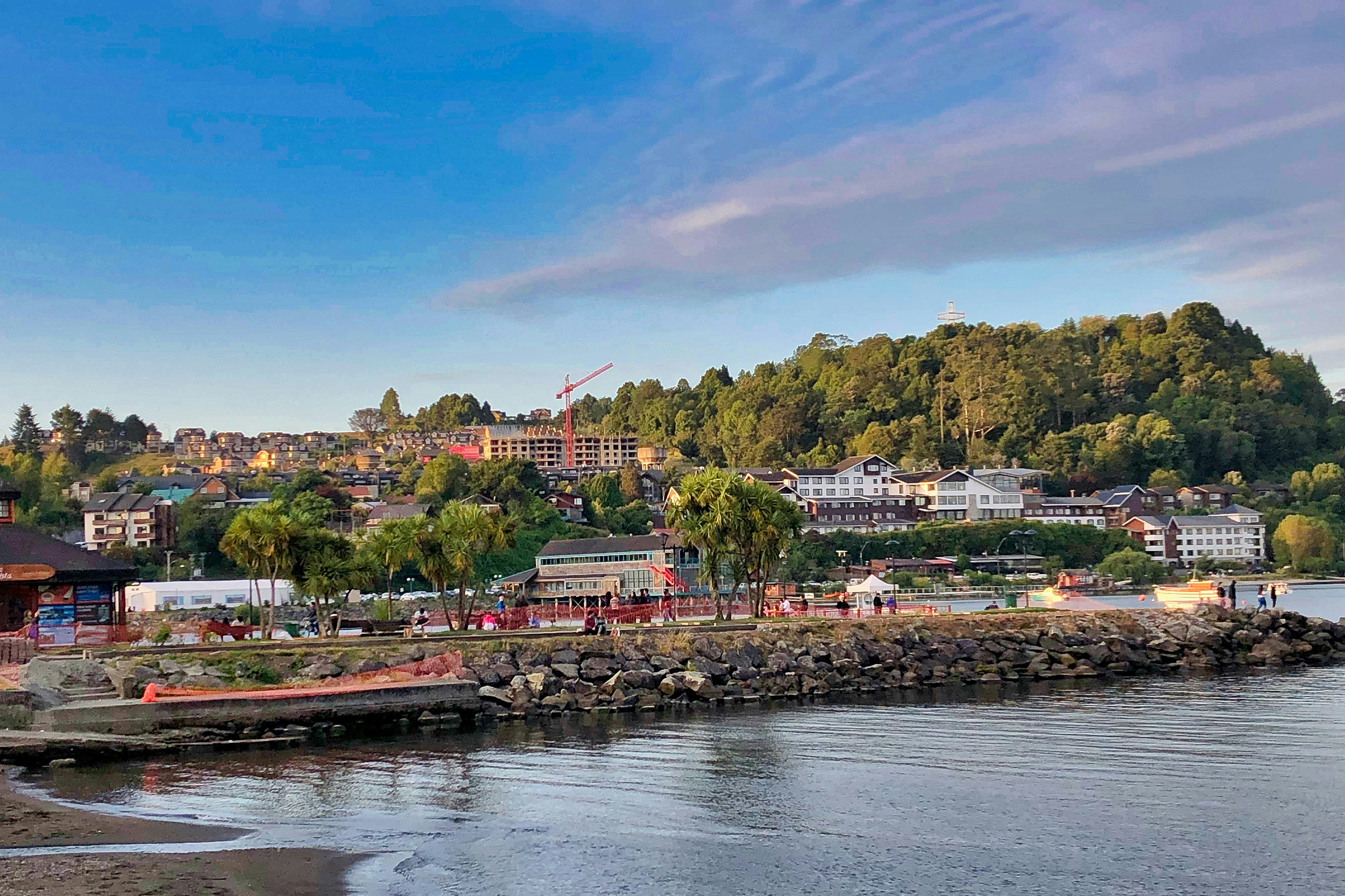 Shore view of Puerto Varas with lake and mountains for people living in Chile.