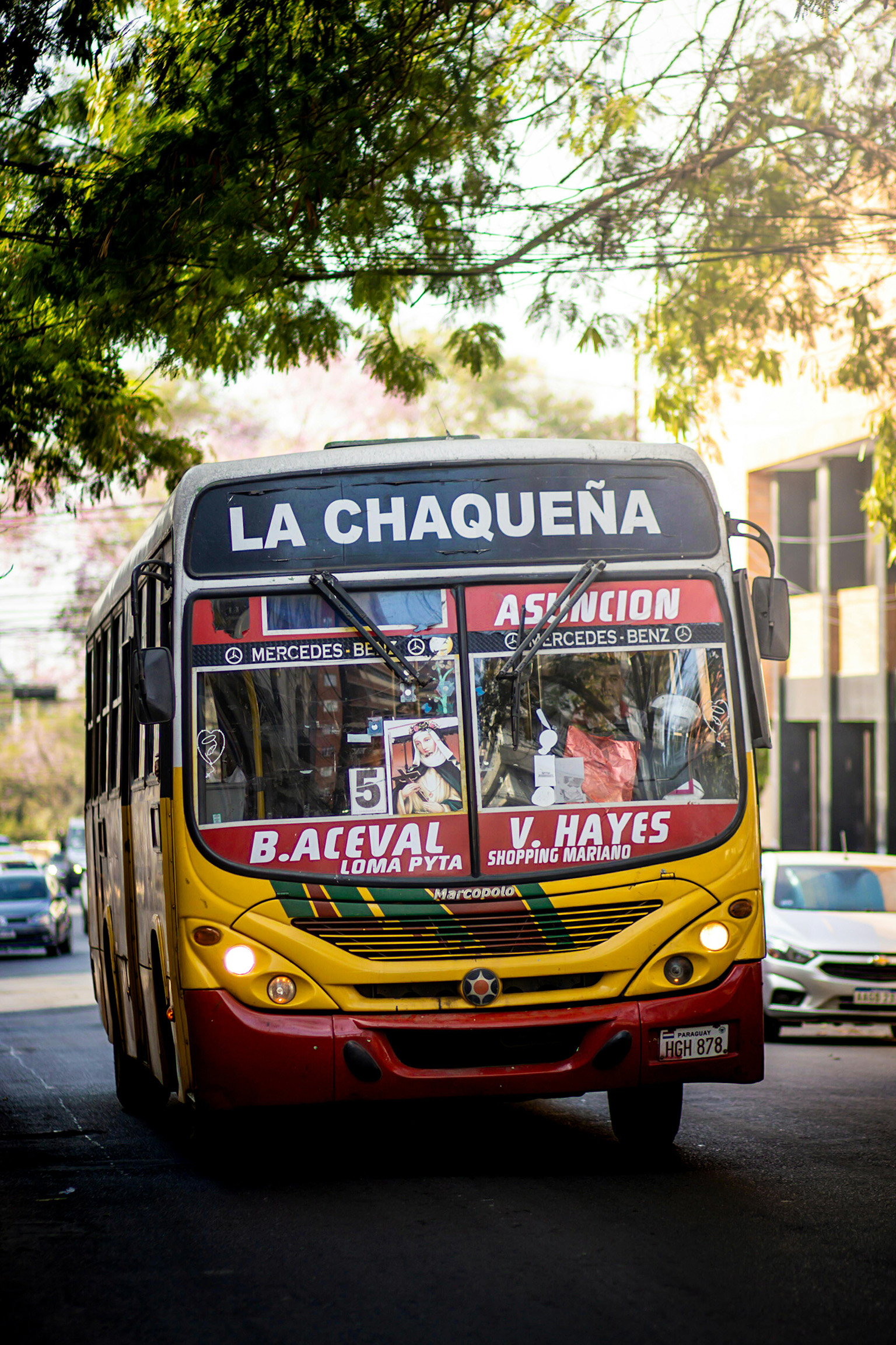 Asunción city bus travels in a busy neighborhood