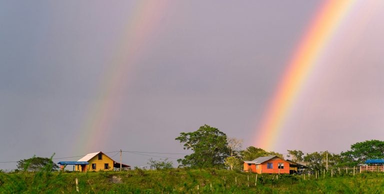 Rainbow over a rural landscape in Belize showing the country’s peaceful countryside lifestyle