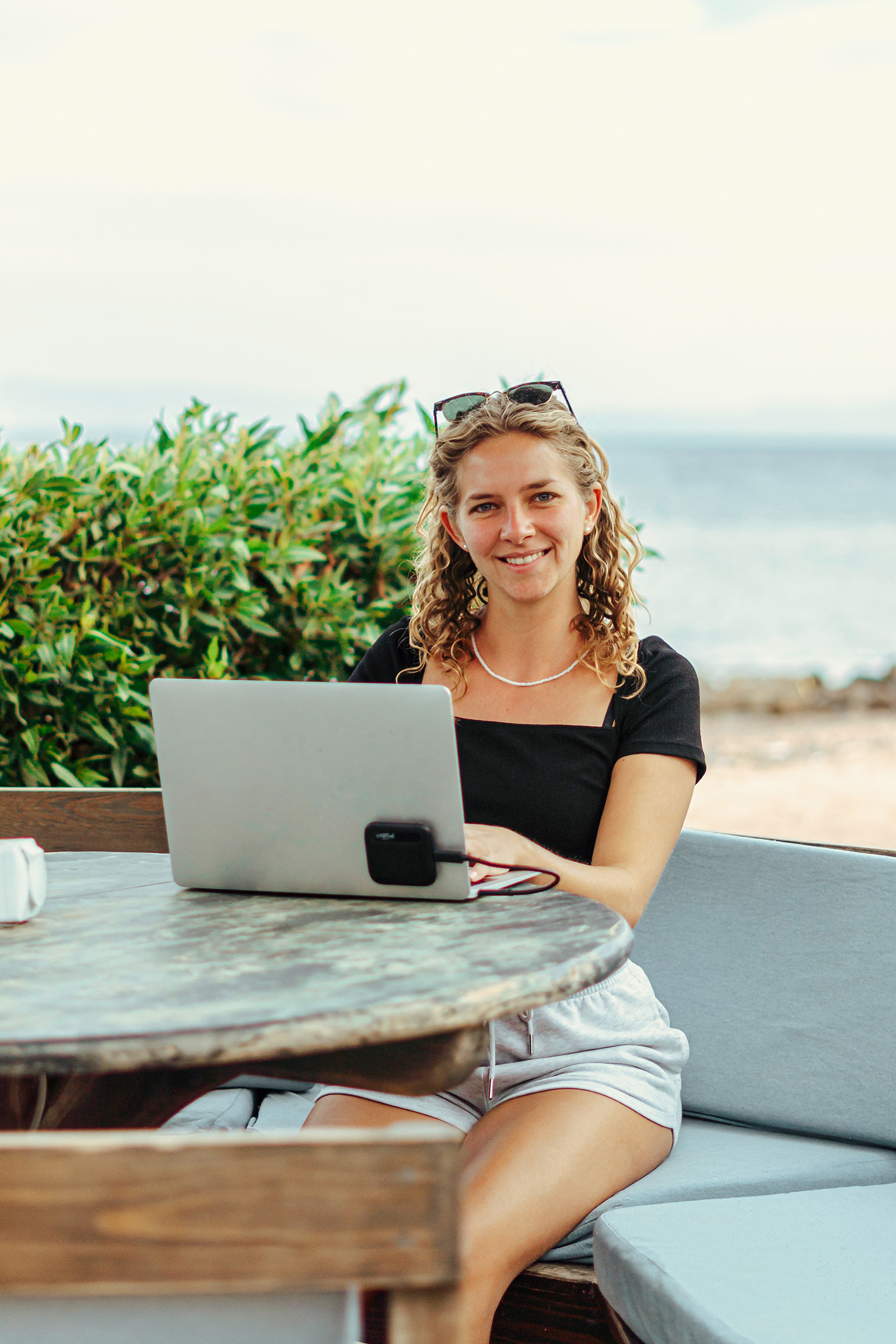 Woman working remotely from Belize with an ocean view