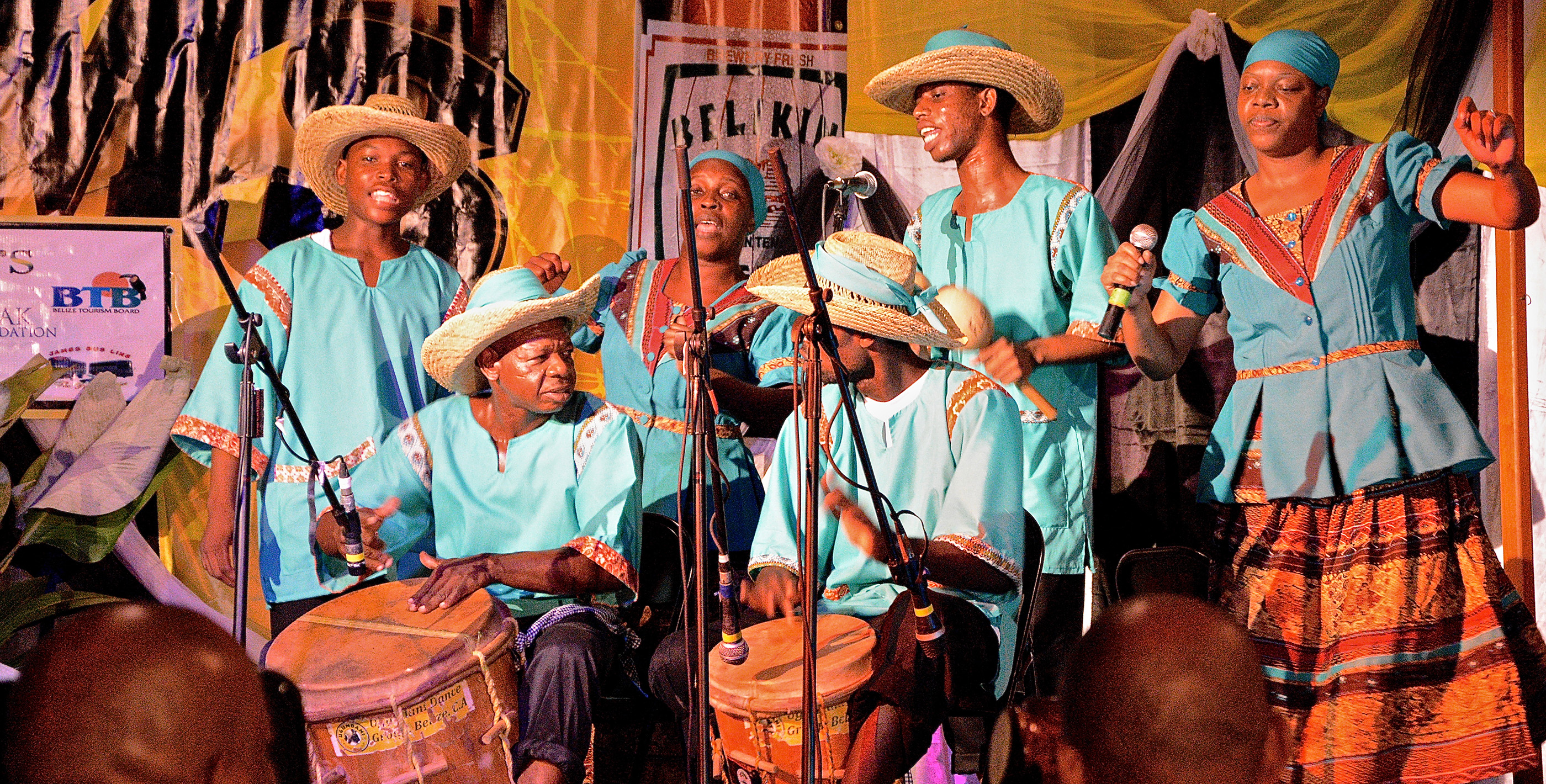 Garifuna musical band in full traditional costume performing in Punta Gorda, Belize—vibrant drums and dances highlighting living in Punta Gorda Belize culture.