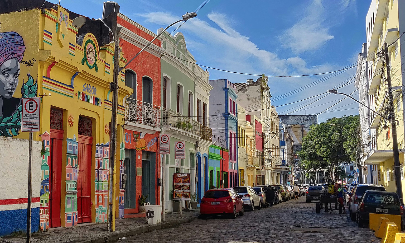 Colorful colonial buildings along a vibrant street in Recife, Brazil.