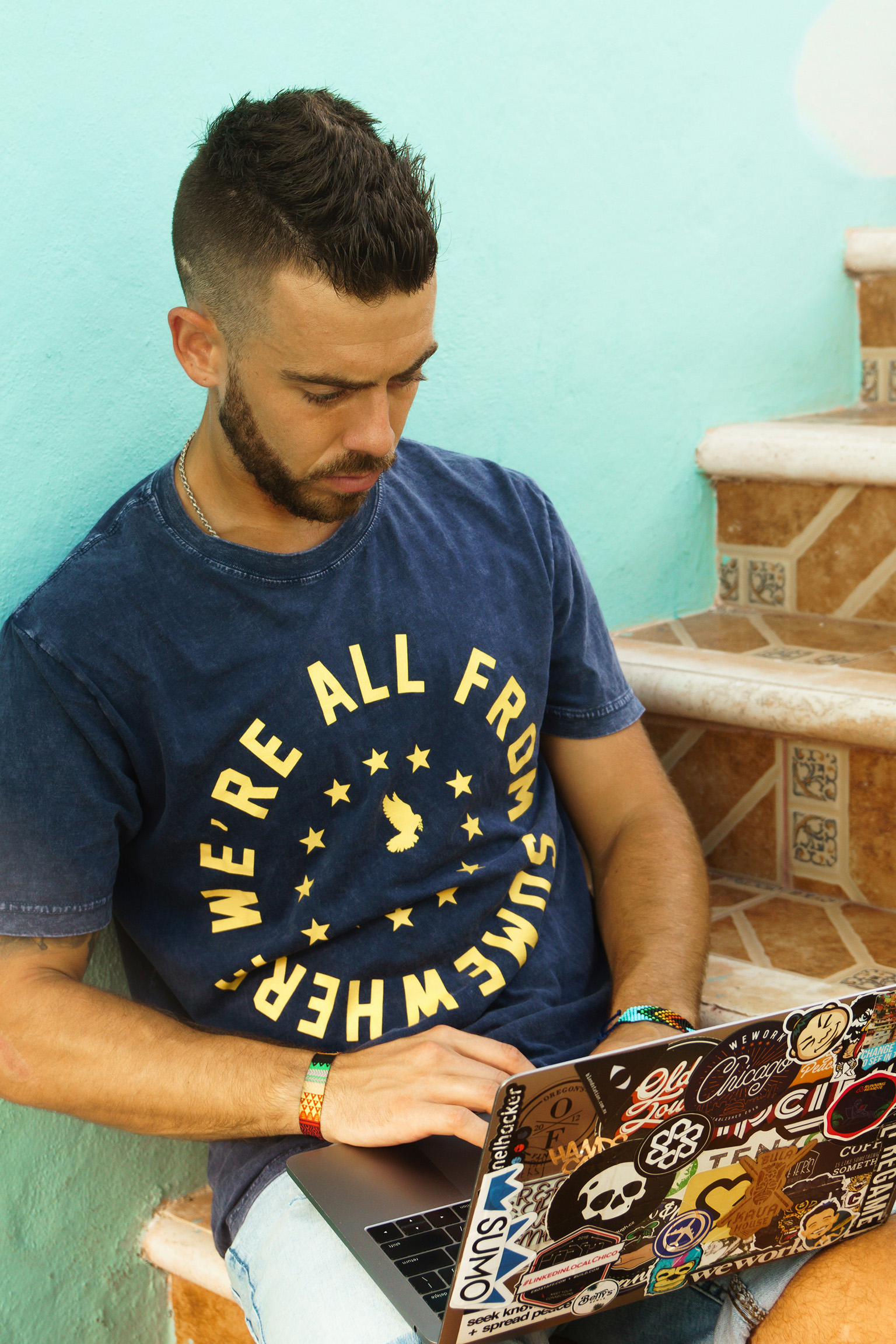 Digital nomad working on a laptop outdoors near the beach in Peru.