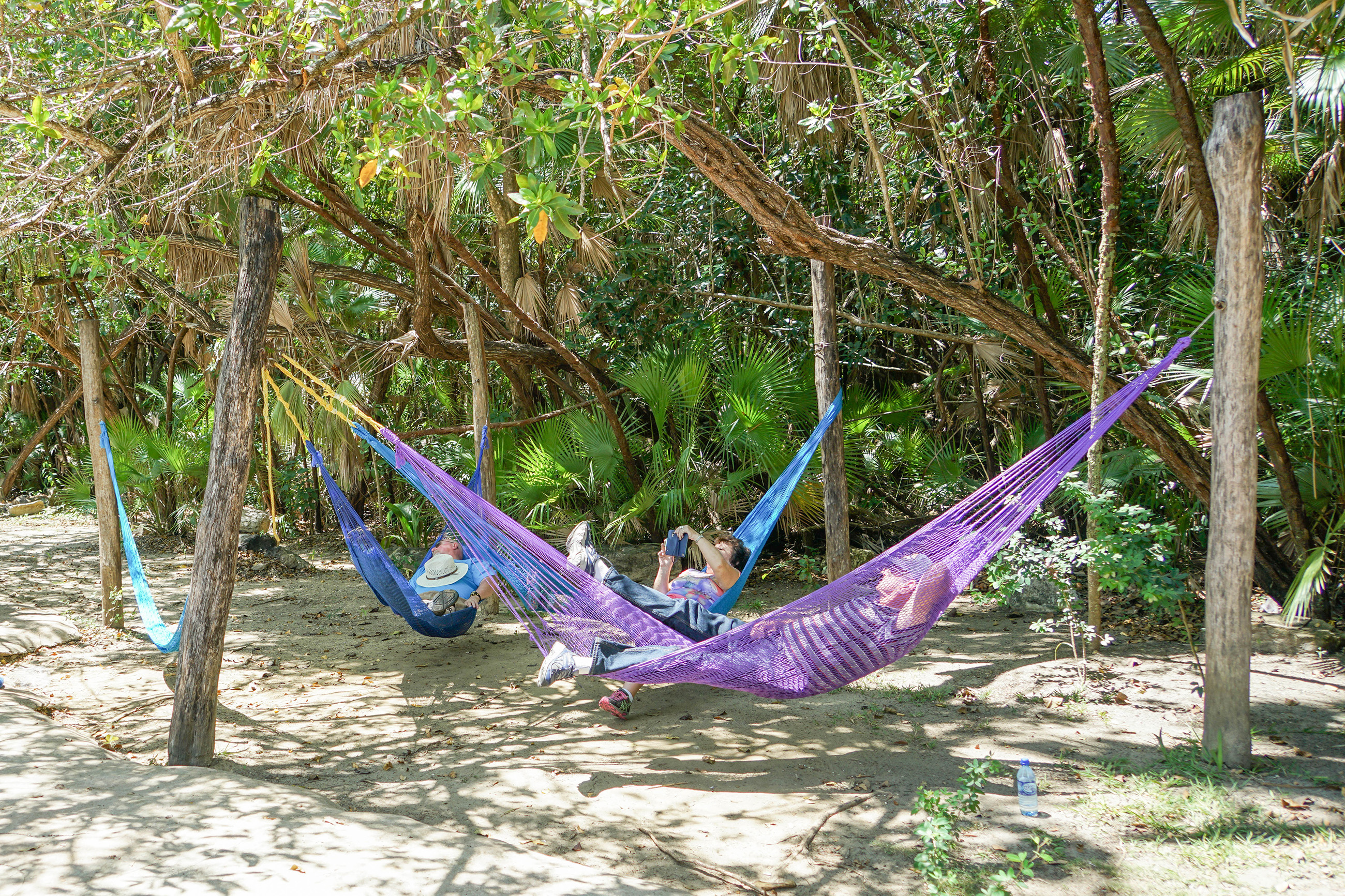 People relaxing in hammocks on a Belize beach
