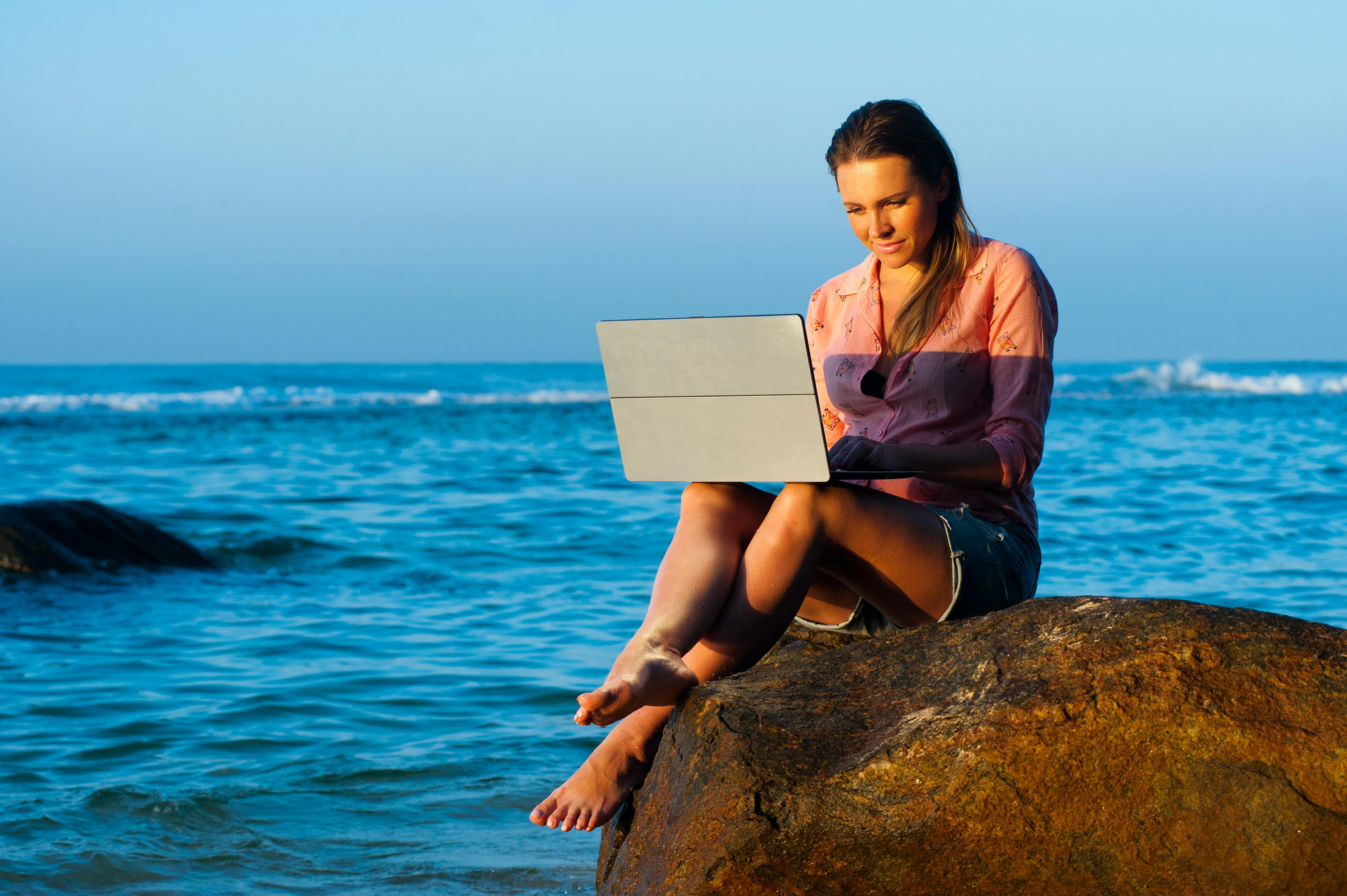 Woman working remotely in Belize on a laptop