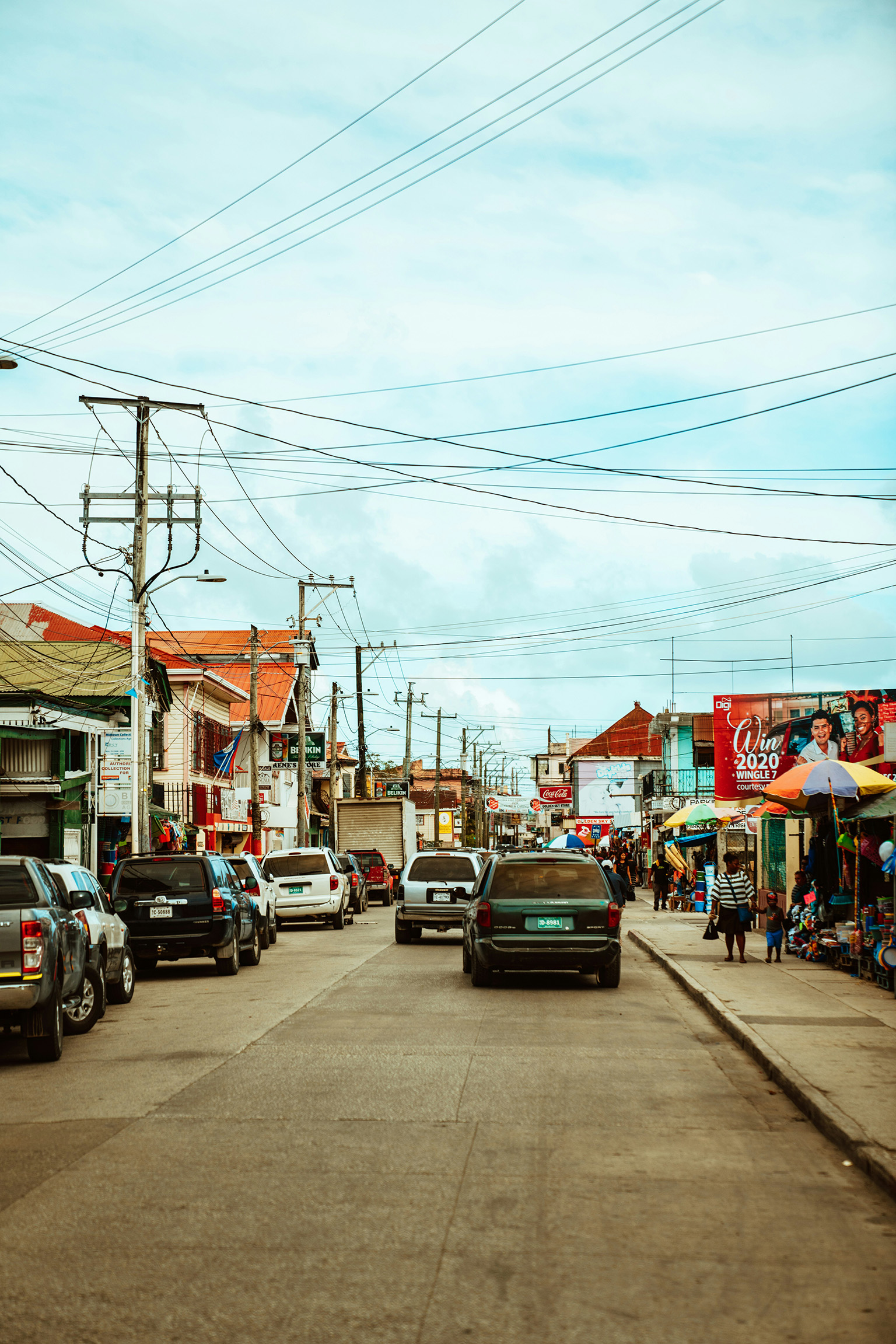 belize-city-busy-street-urban-safety-awareness A busy street in downtown Belize City showing traffic, pedestrians, and urban activity.