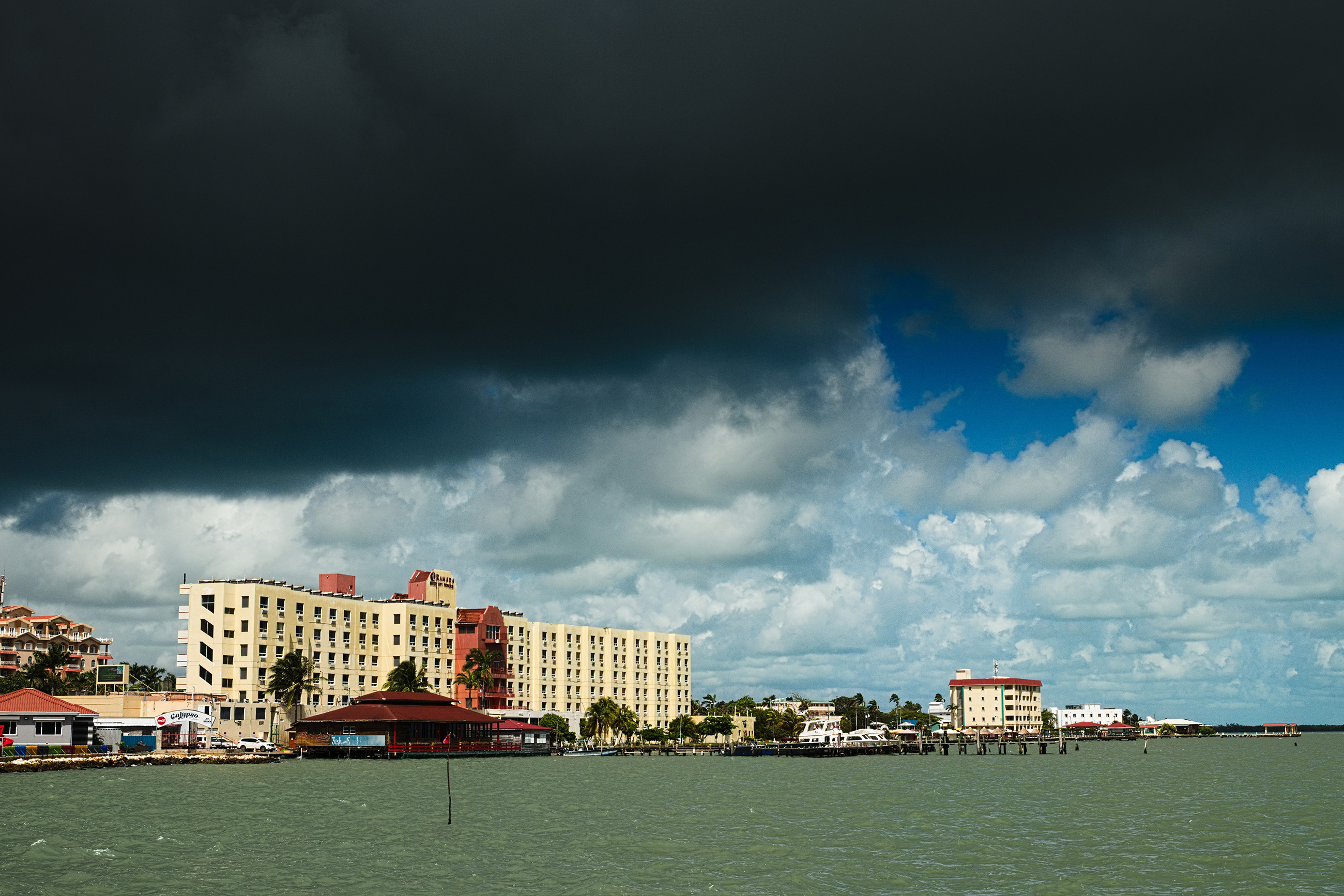 belize-city-princess-hotel-overcast-weather-safety Belize City Princess Hotel under an overcast sky highlighting Belize’s unpredictable weather.