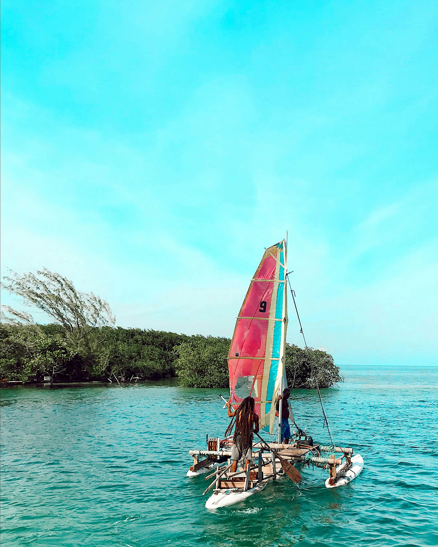 A makeshift catamaran used for everyday transportation around Ambergris, reflecting real daily life logistics
