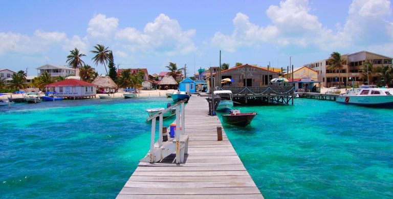 Small village dock overlooking clear turquoise water in Belize, highlighting safety in Belize for expats
