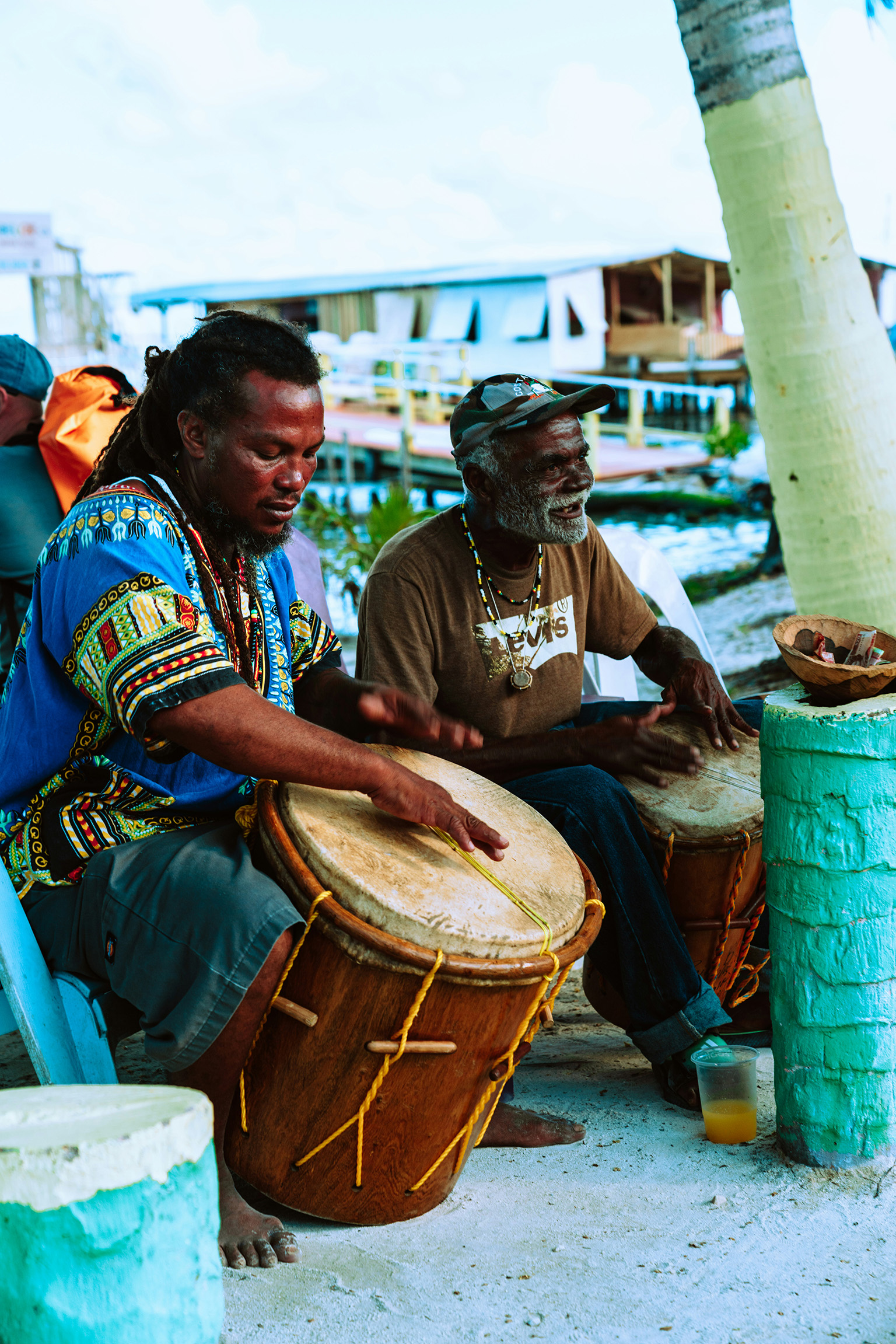 Locals playing handmade drums on Caye Caulker, capturing Belize daily life and island culture