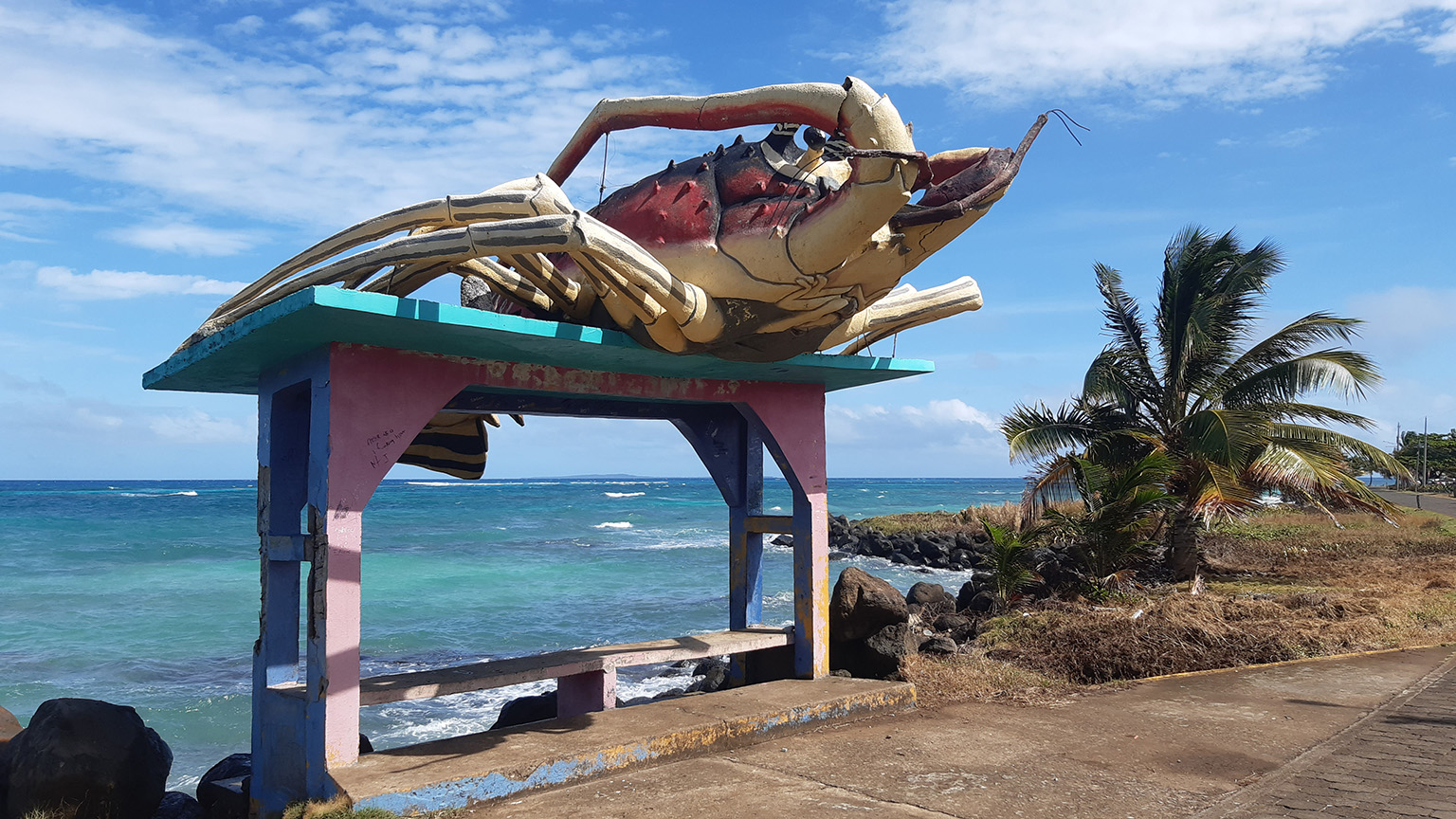 Lobster sculpture on bus stop roof with Caribbean ocean background on the Corn Islands Nicaragua