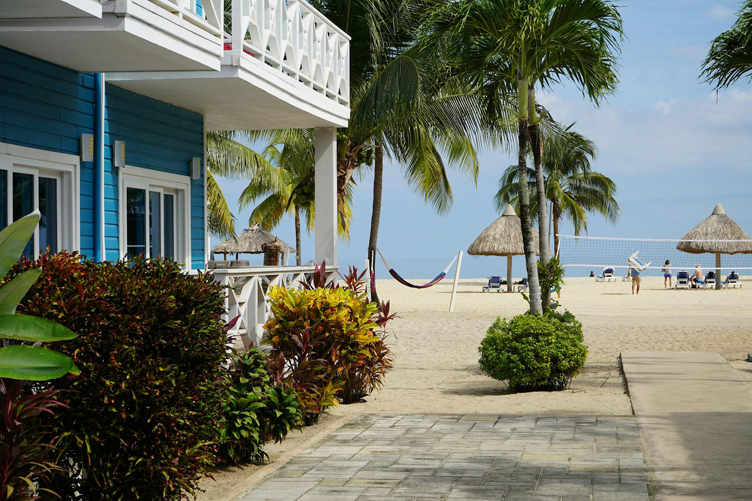 View of the beach from a street in Placencia Belize, showing everyday coastal living in Belize