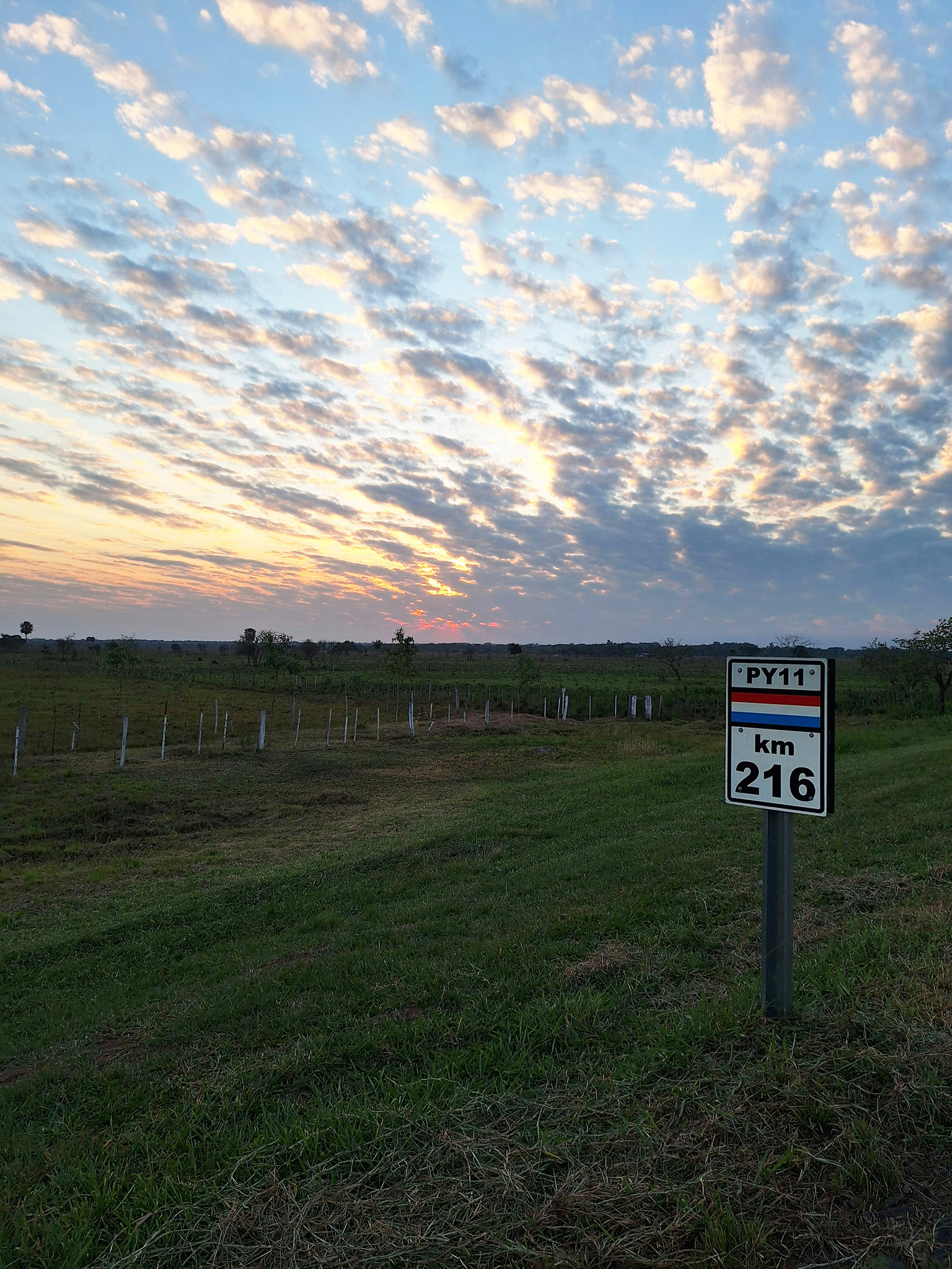 py11-road-sign-rural-paraguay-buying-property PY11 road sign in rural Paraguay landscape – discover affordable countryside when buying property in Paraguay for foreigners 2026