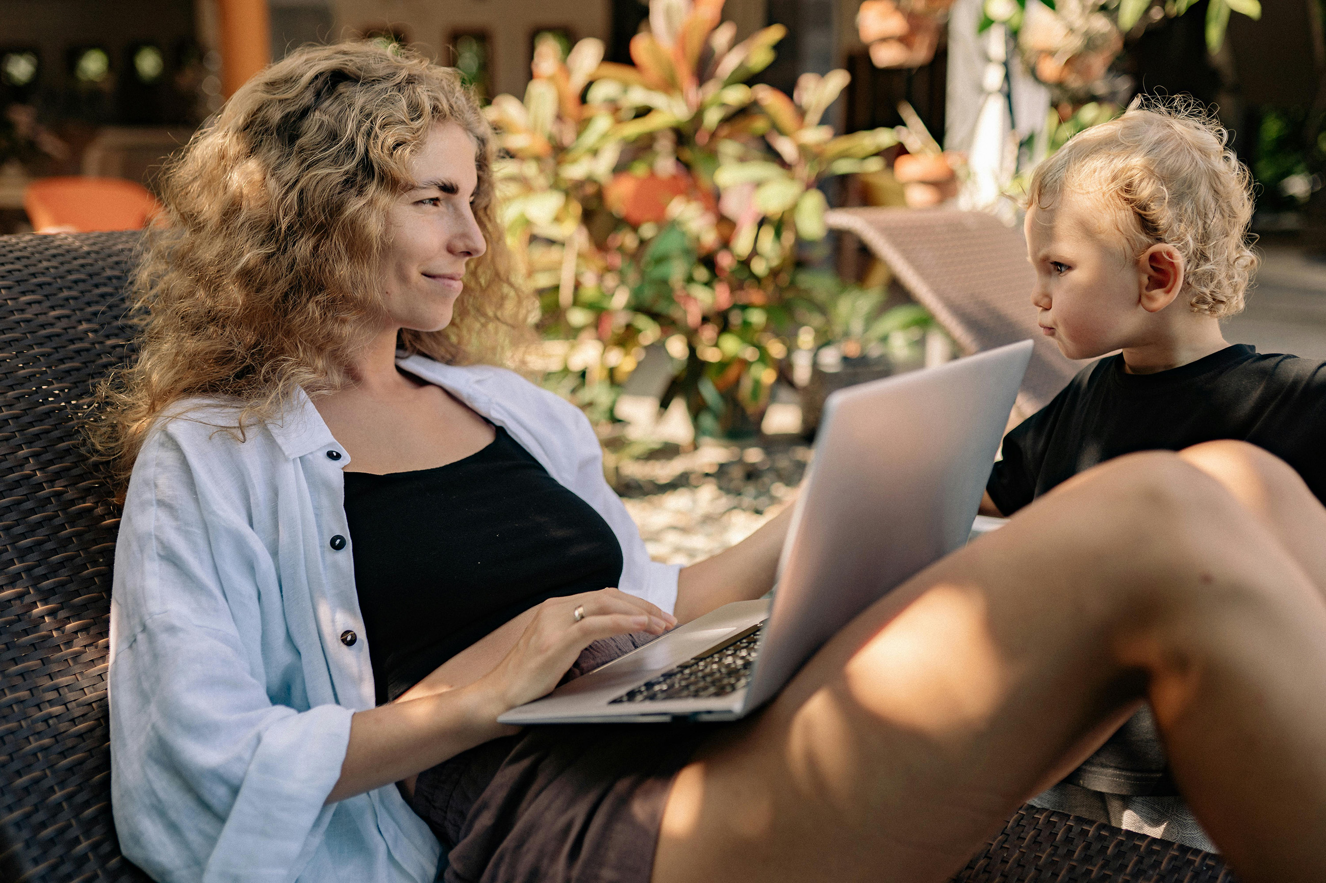 Remote worker on laptop with son in a café on the Corn Islands Nicaragua