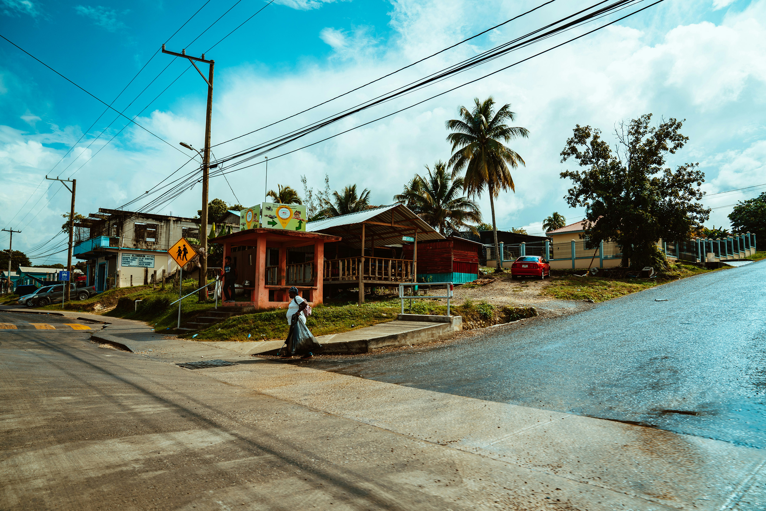 san-ignacio-belize-neighborhood-crosswalk-local-homes Neighborhood homes near a crosswalk and bus stop in San Ignacio, one of the safer inland towns in Belize.