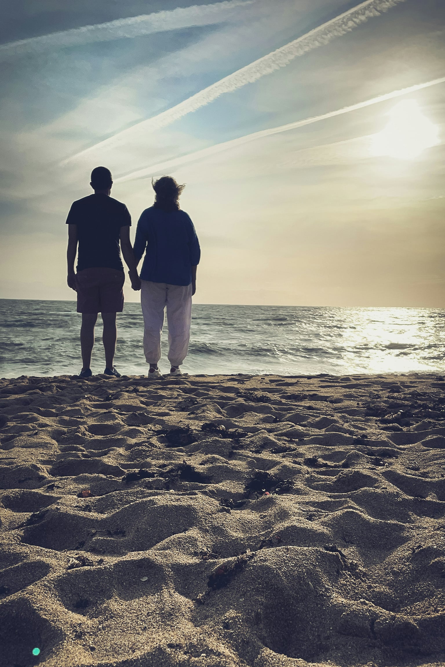 Retired couple enjoying beach sunset, symbolizing lifestyle, and healthcare in Belize