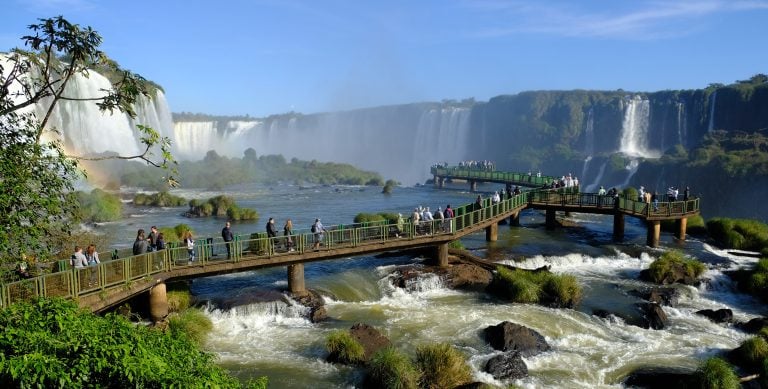 Retired couple enjoying Iguazú Falls while planning how to manage your finances in Paraguay as a retiree