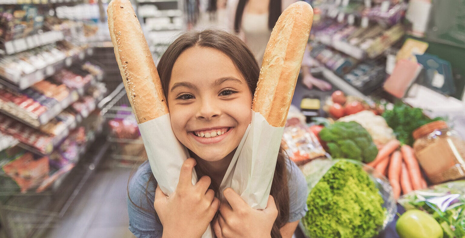 Young girl grocery shopping in Paraguay, reflecting low cost of living