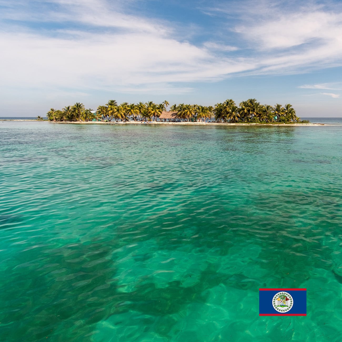 Living in Belize with a view of Laughing Bird Caye and the Belize flag from the water