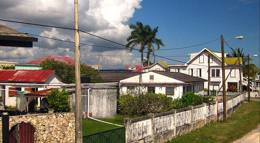 Living in Belize in Corozal with traditional wooden homes along a quiet road