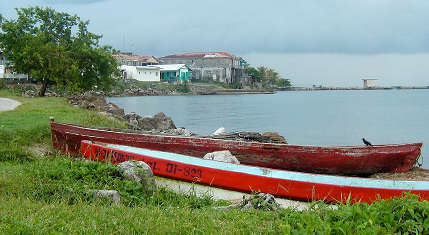 Living in Belize in Punta Gorda with small boats along a quiet shoreline
