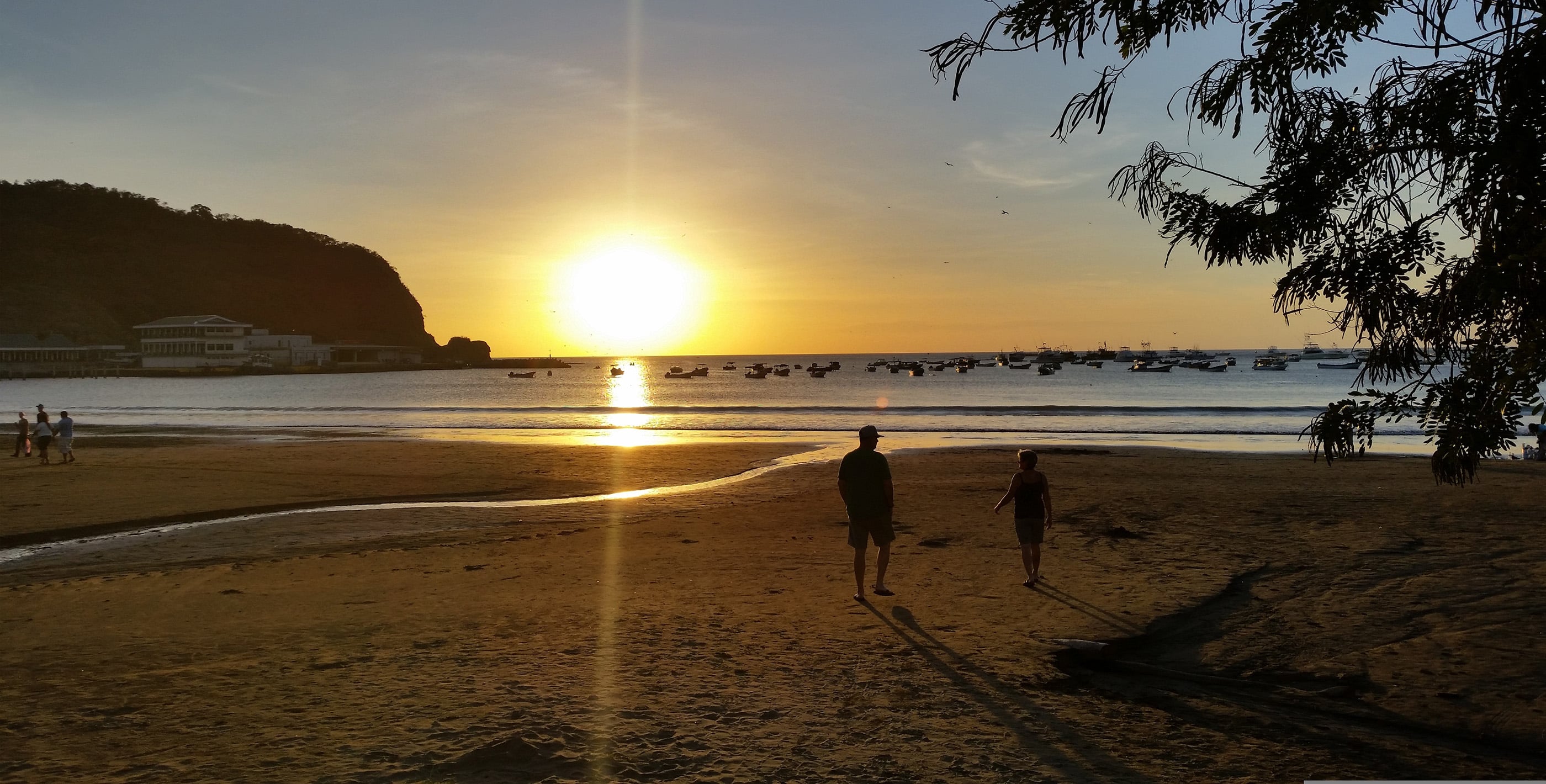People enjoying a tropical Nicaraguan beach at sunset