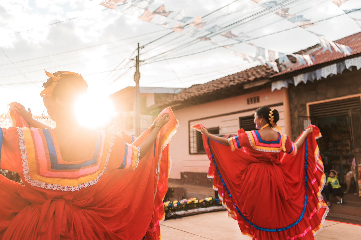 Women dancing in traditional Nicaraguan dress during a parade 