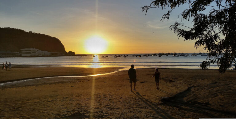 People enjoying a tropical Nicaraguan beach at sunset