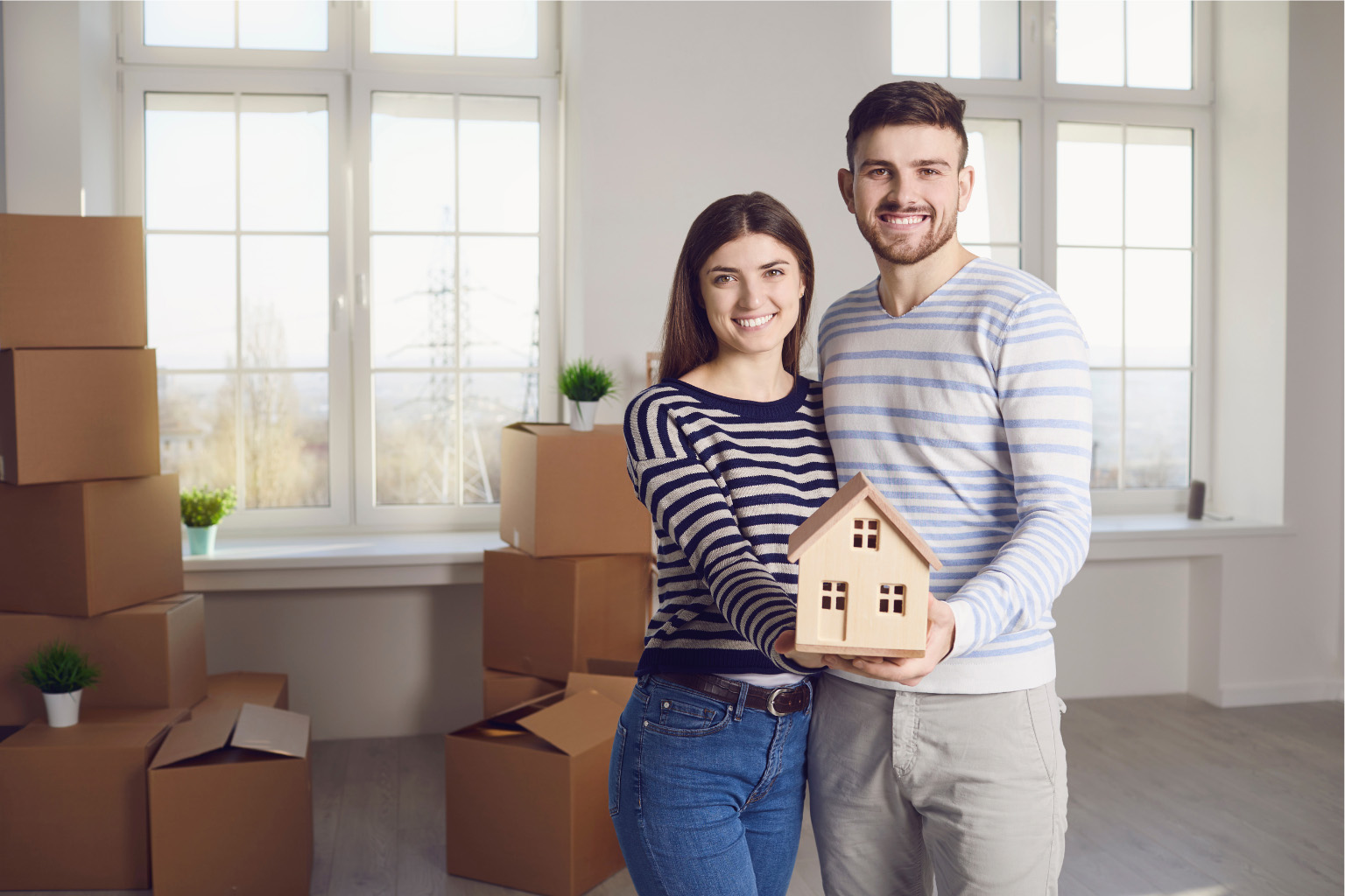 buying-property-paraguay-happy-couple-new-home Couple celebrating new home purchase in Paraguay representing benefits of buying property