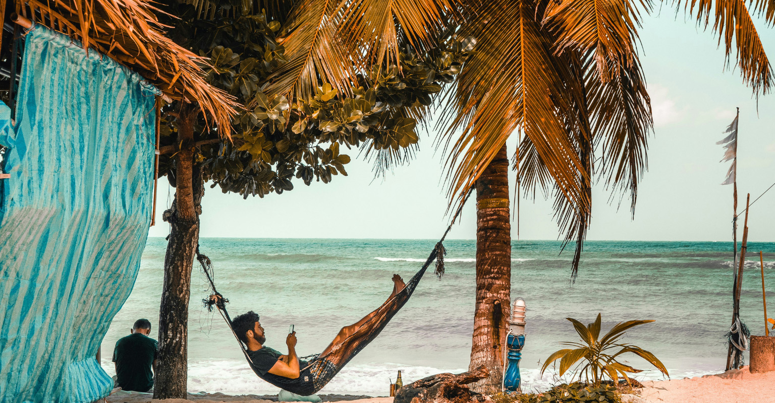 Expats relaxing in a Belize hammock assuming reliable internet - a common mistake moving to Belize