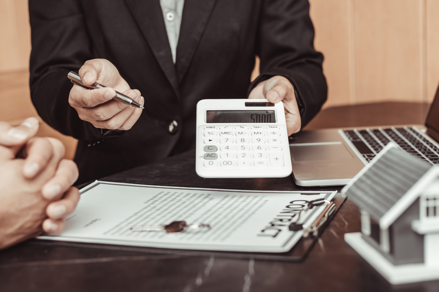 renting-costs-paraguay-calculator-contract People reviewing contract and calculator discussing renting vs buying in Paraguay costs