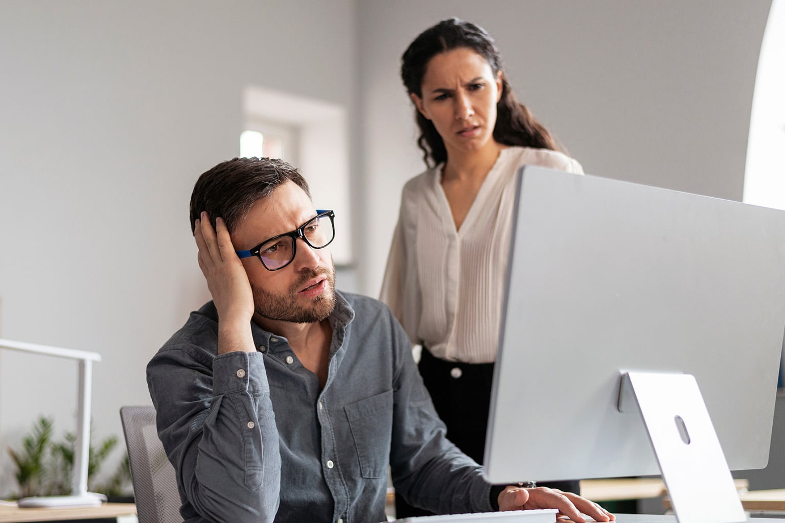 belize-qrp-application-frustrated-couple-desk Couple looking frustrated while applying for Belize Qualified Retirement Program 2026