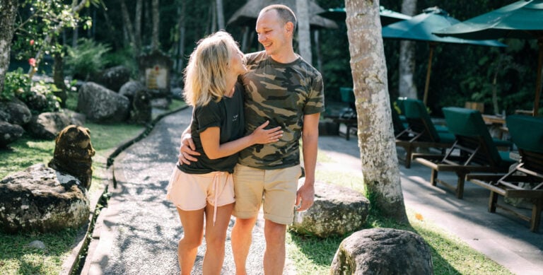 Belize Qualified Retirement Program 2026 happy couple enjoying long-term living on a tropical path