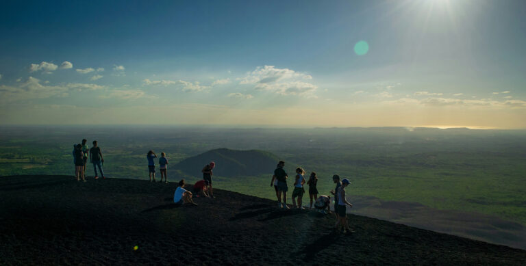 People standing on Volcán Cerro Negro in Nicaragua, unaware of the tax rules that come with life here